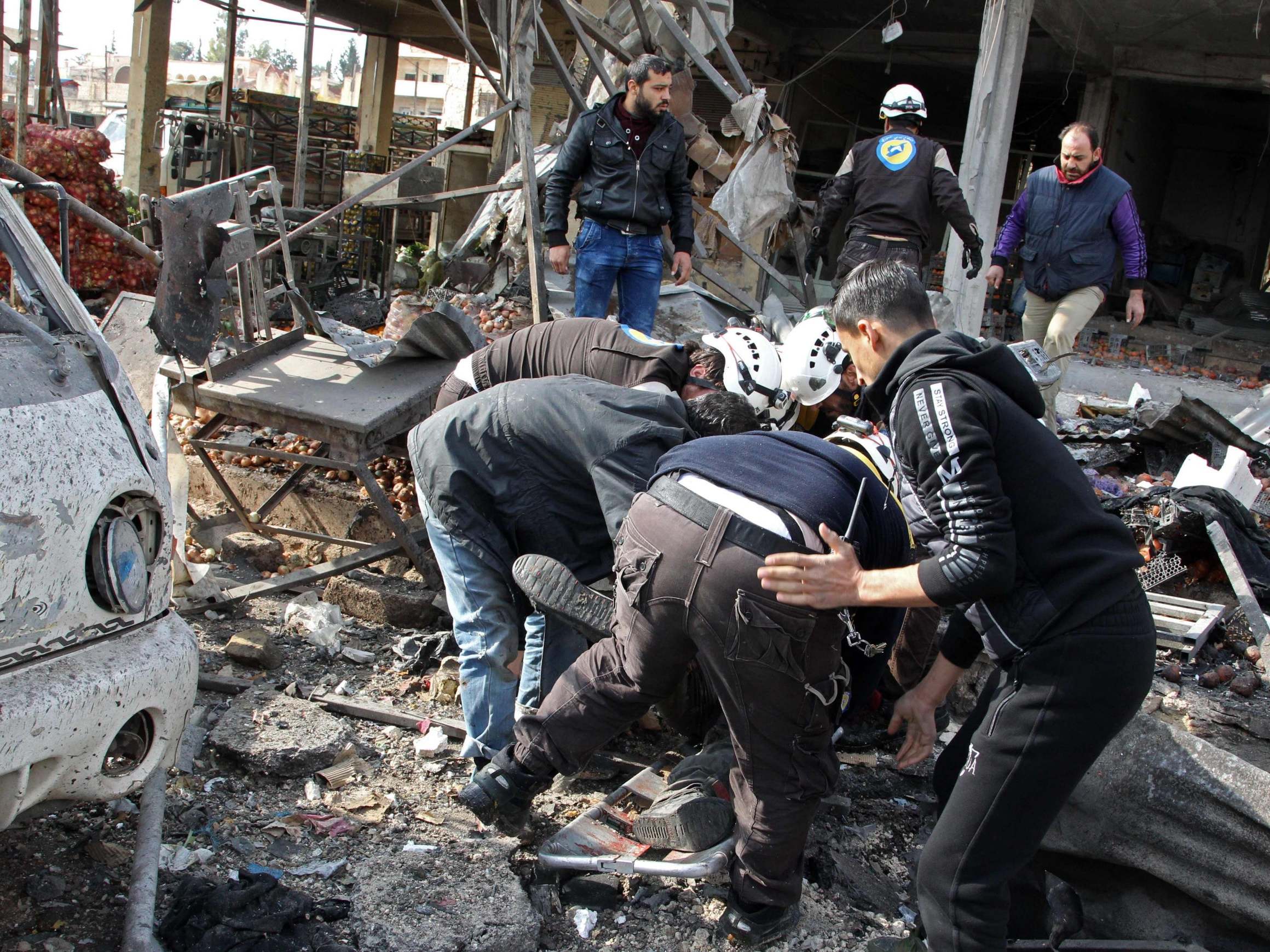 Syrians try to recover victims caught in the rubble following a regime airstrike (AFP/Getty)