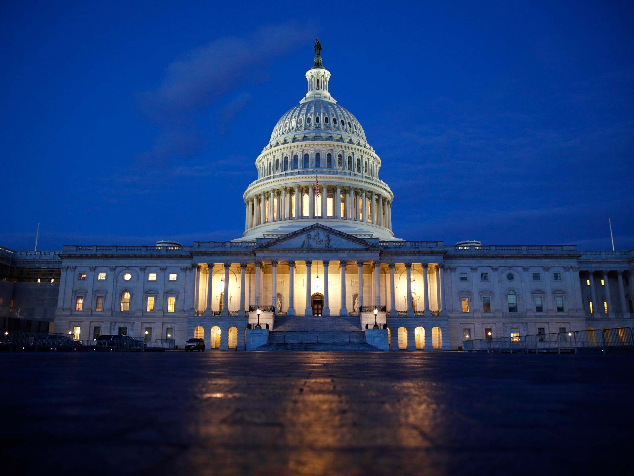 Light shines on the US Capitol dome in Washington, early Wednesday 4 December