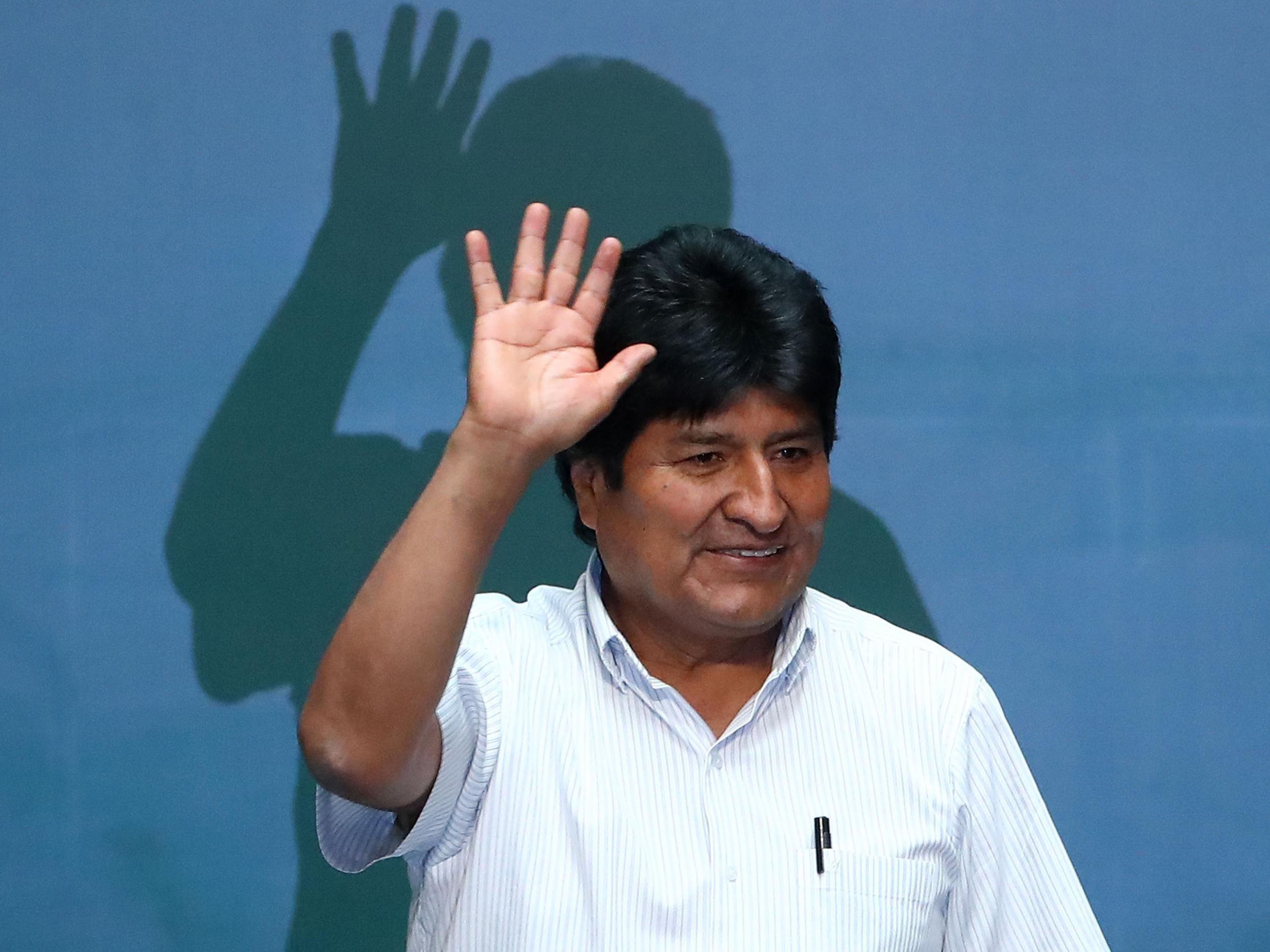 Evo Morales waves during an event to distinguish him as honorary guest at City Hall in Mexico City