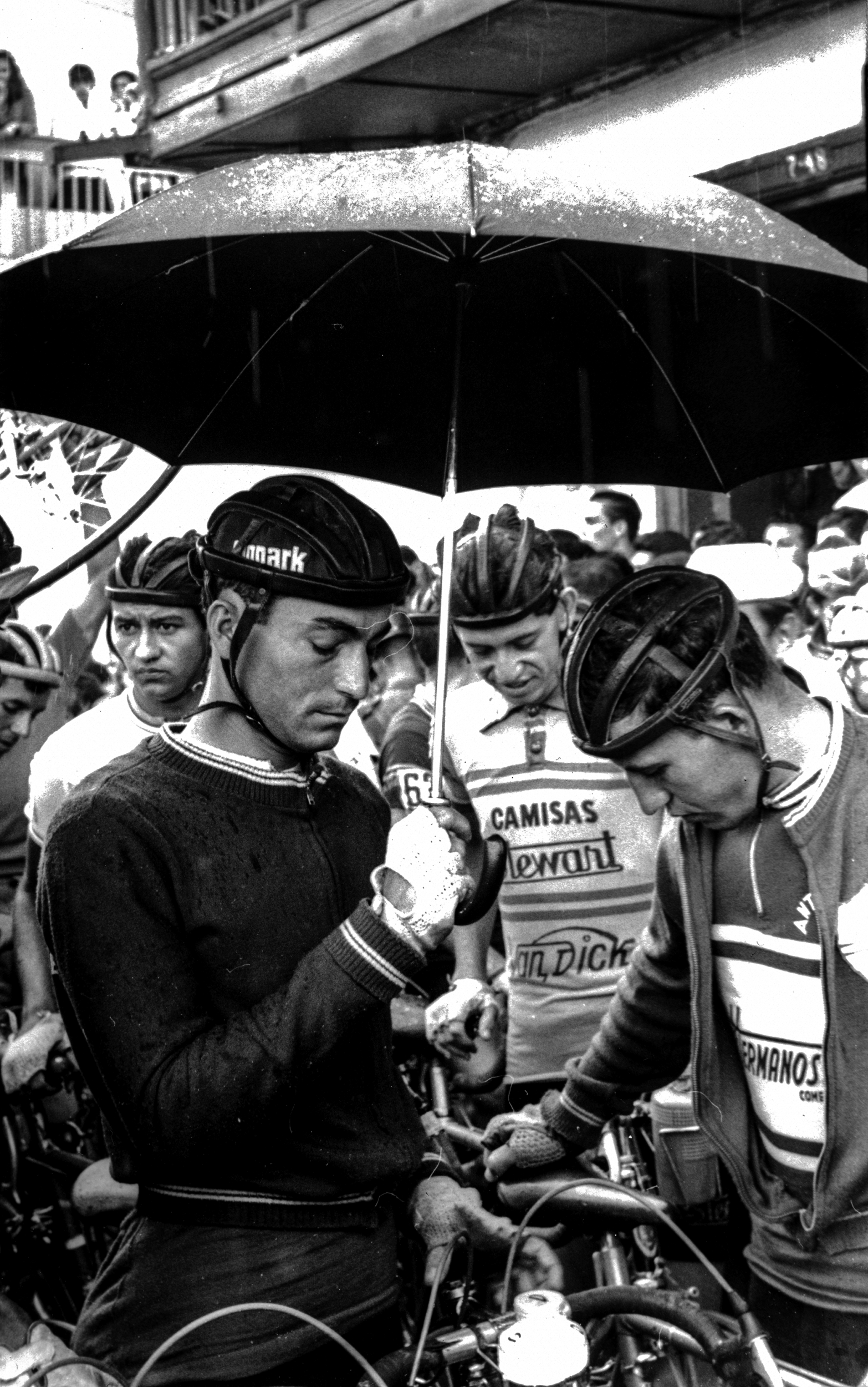 Roberto Escobar sheltering under an umbrella