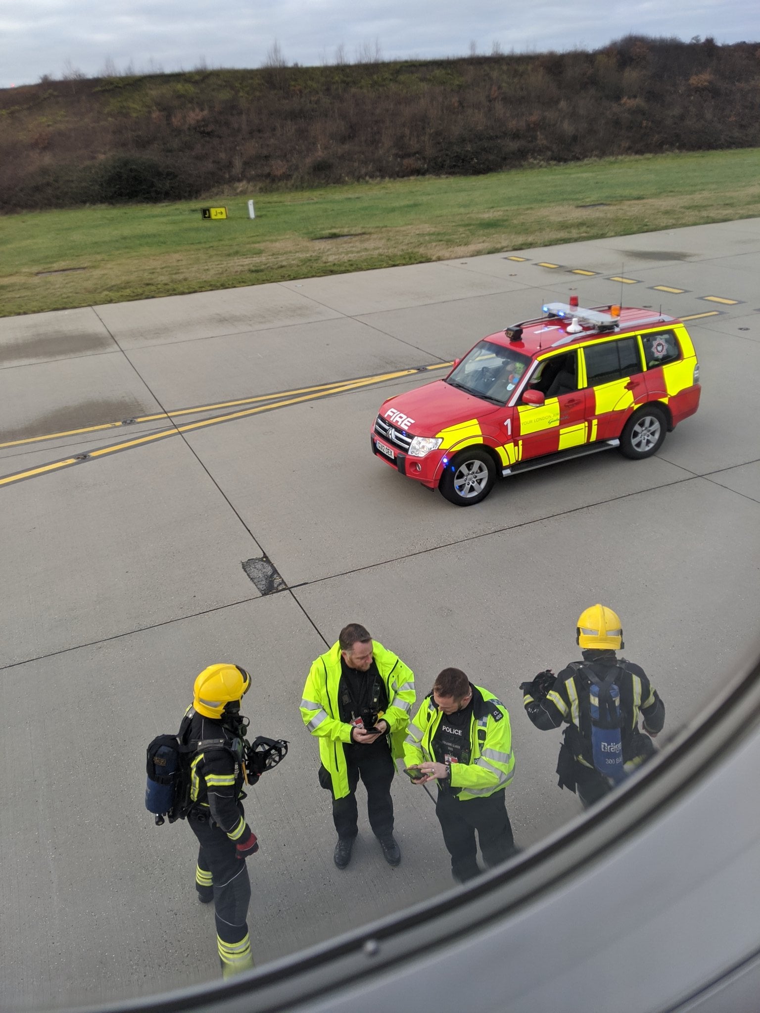 Police and fire crews prepare to board the plane