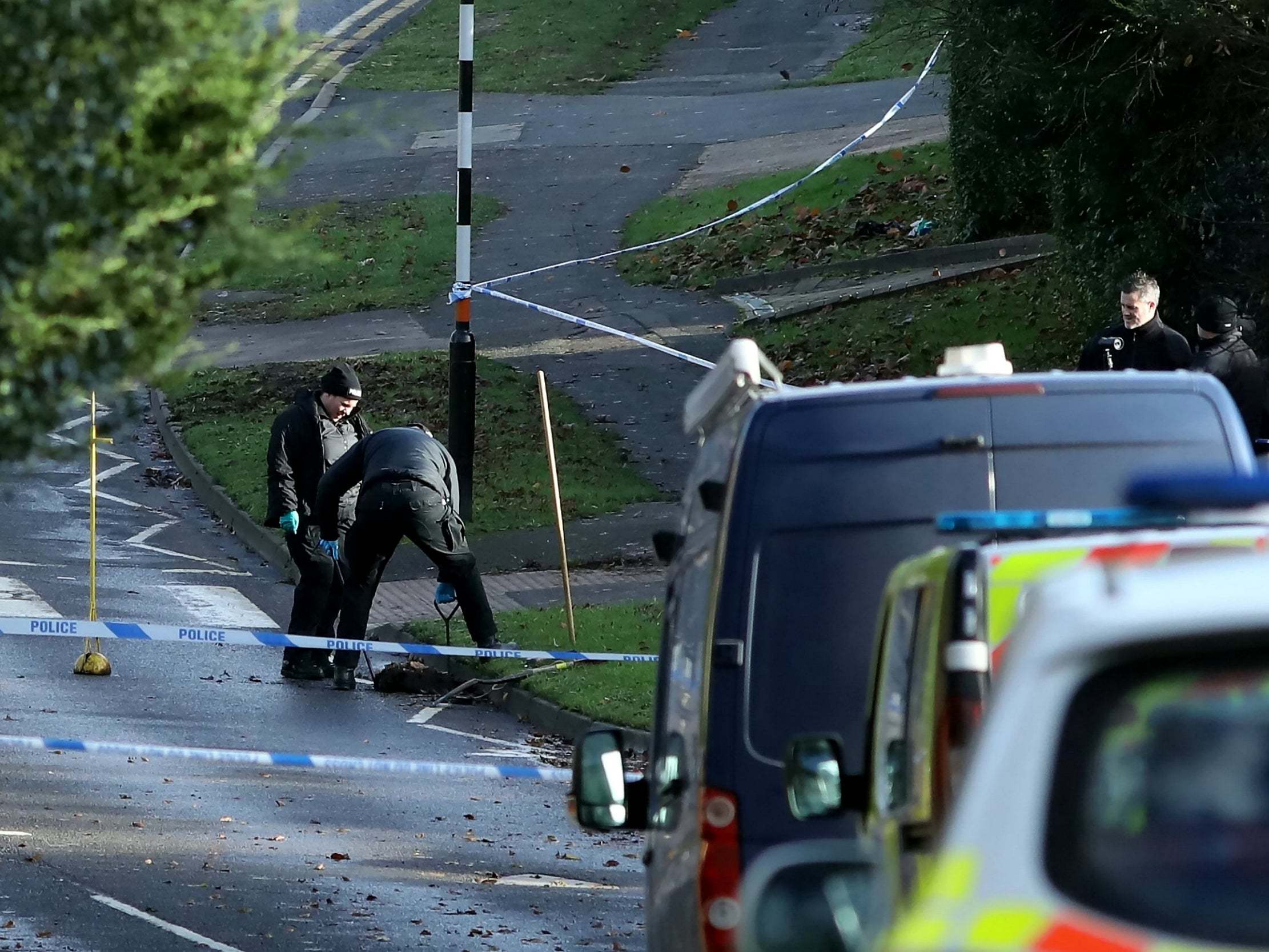 Police hunt for clues in the road where a 25-year-old woman was stabbed to death