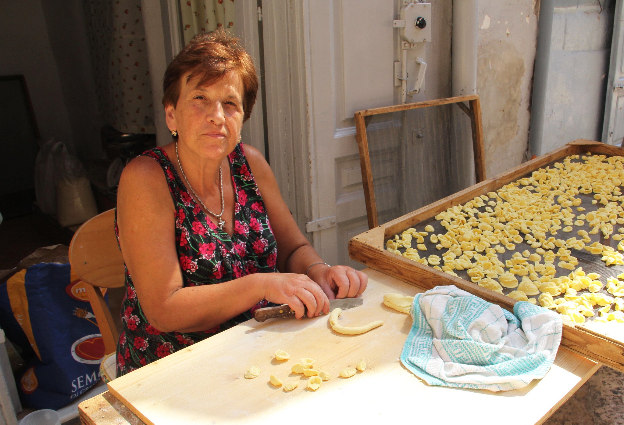 Angela Lastella makes and sells her orecchiette at a station outside her home