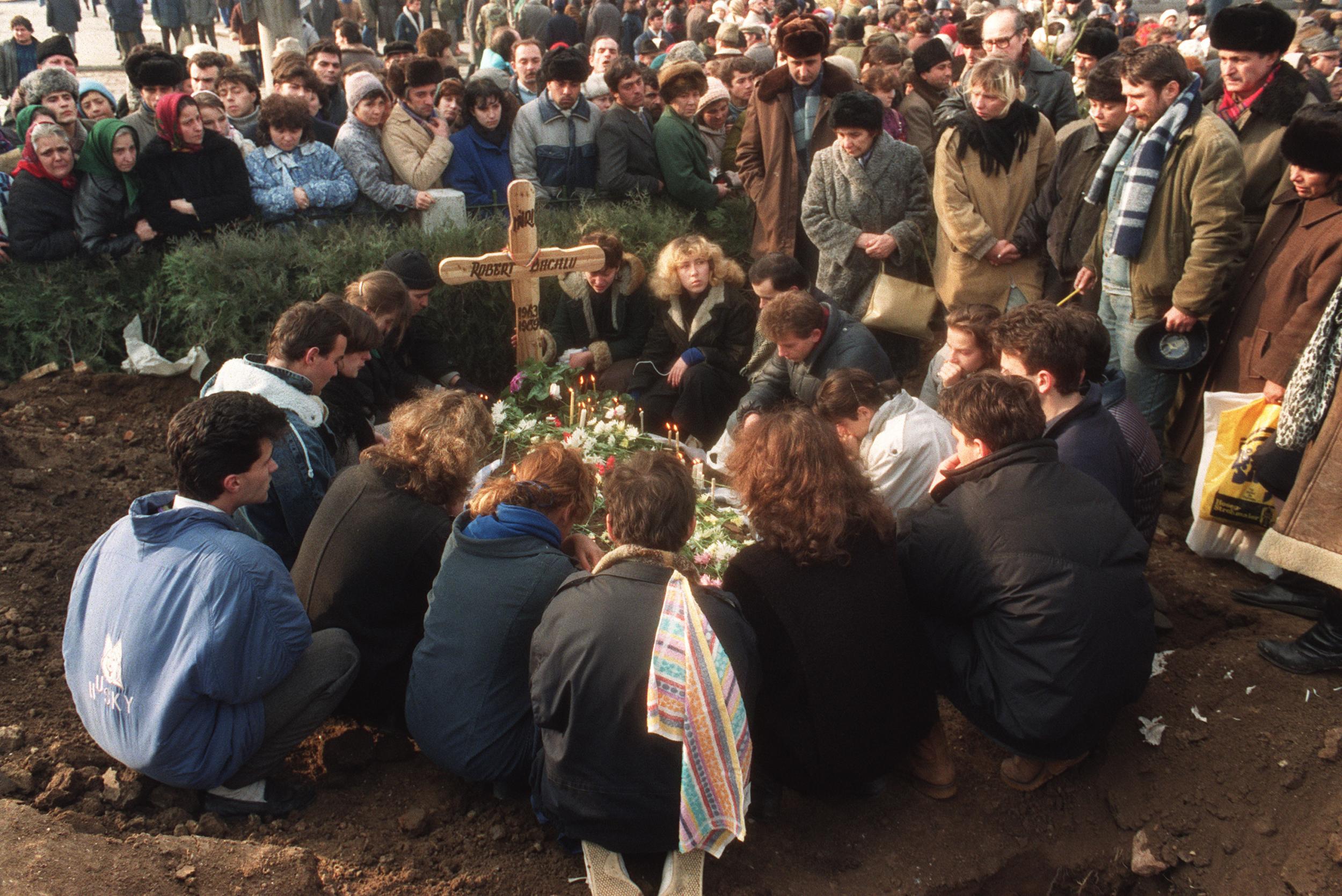 Crowds pack the cemetery: about 500 civilians were killed in the fighting