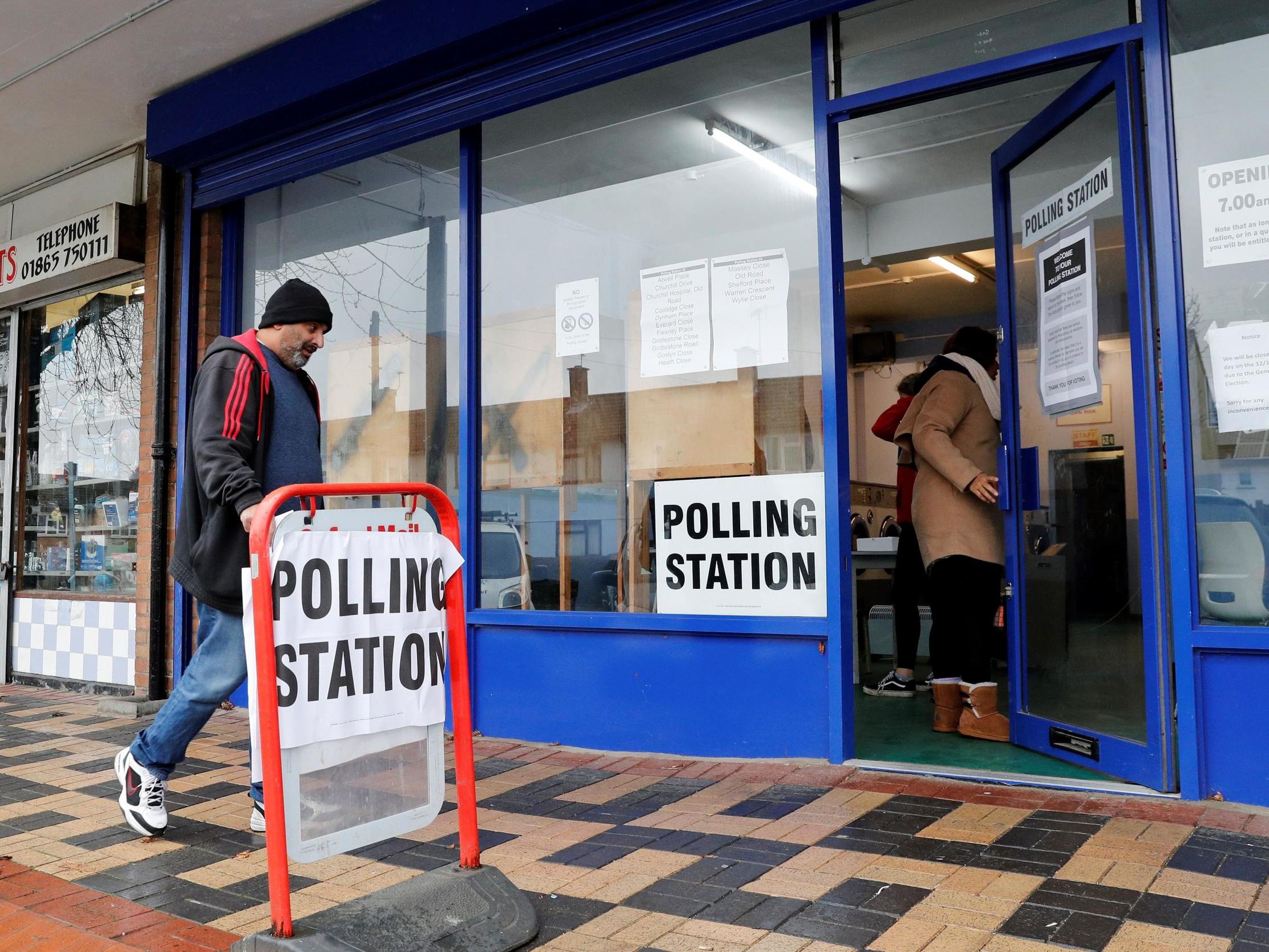 People arrive to cast their votes at a polling station during the general election