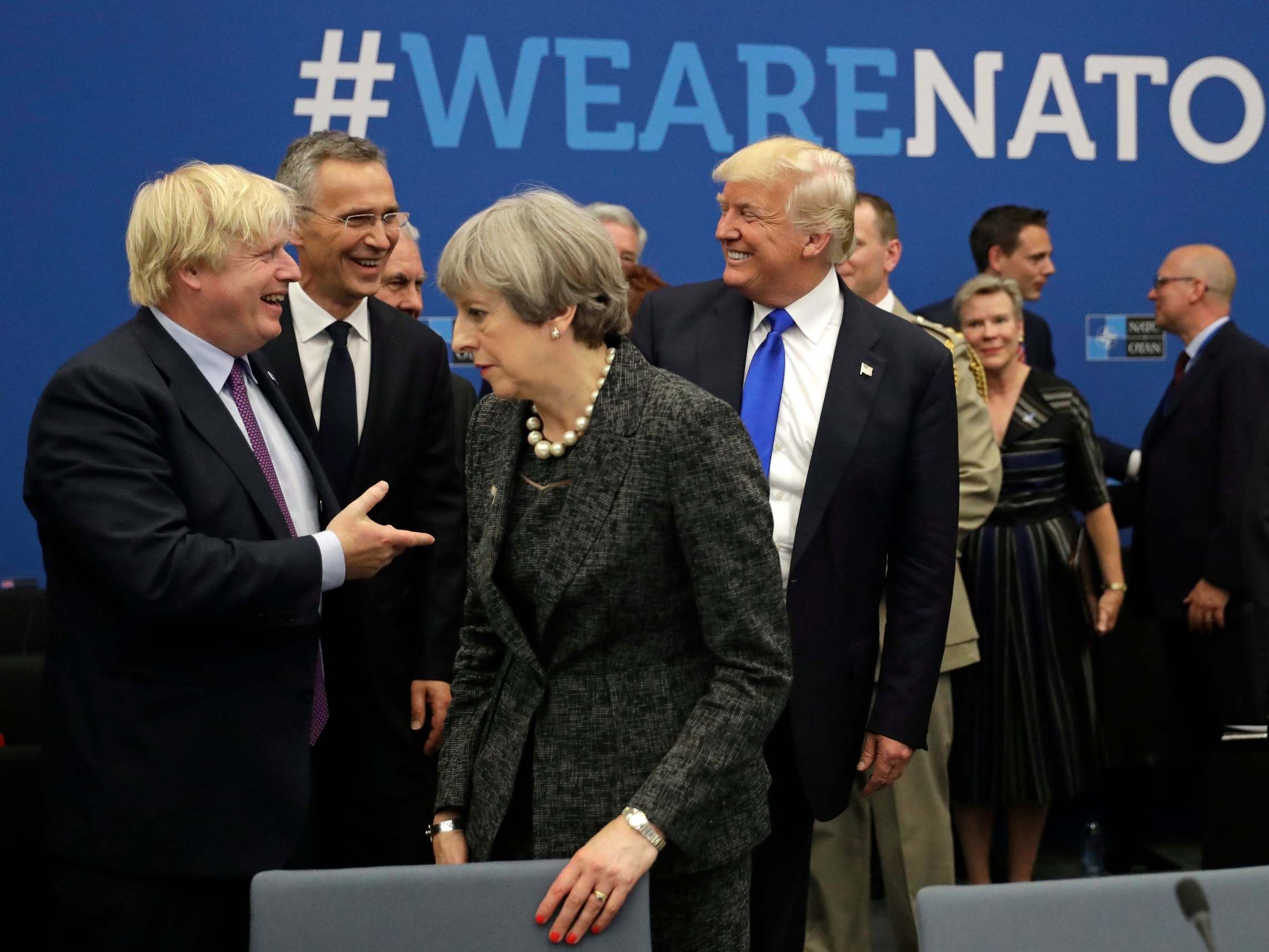 President Donald Trump jokes with then-foreign secretary Boris Johnson as Theresa May walks past during a 2017 Nato