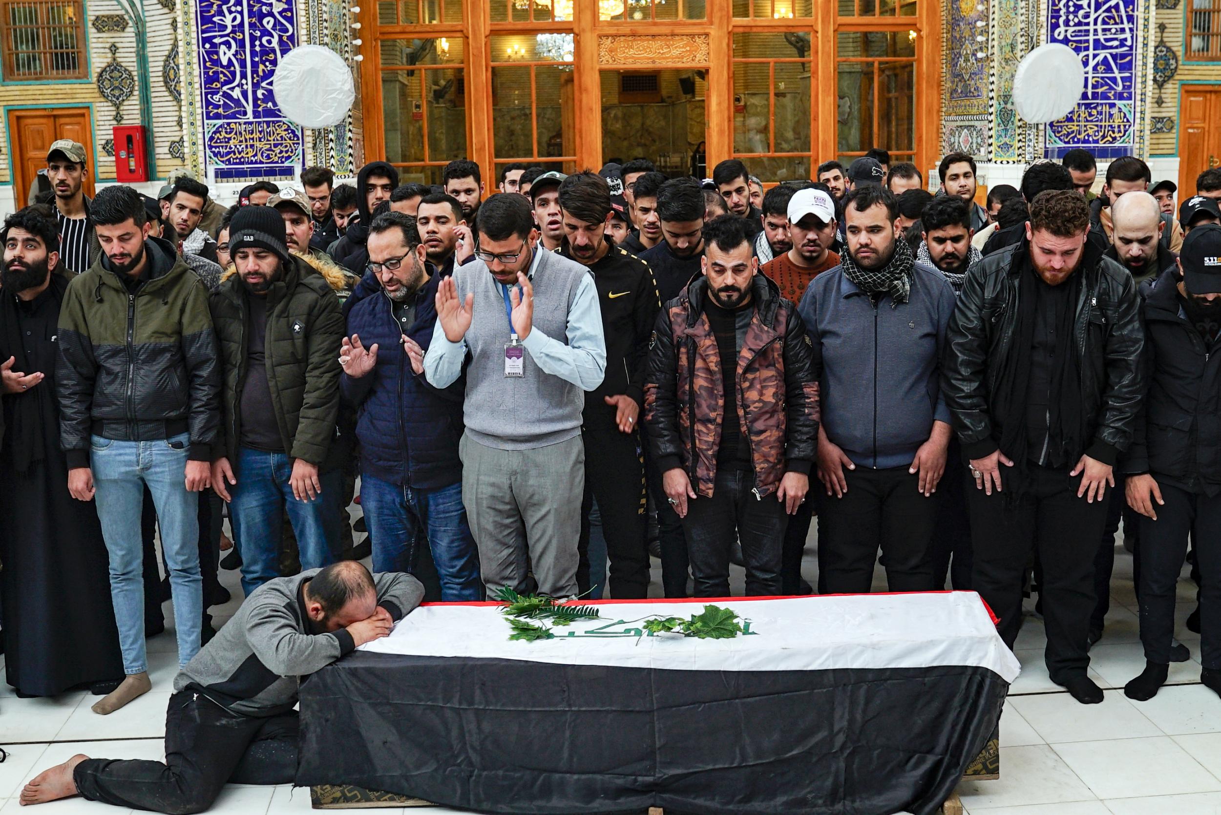 A man weeps by the coffin of an Iraqi protester and citizen journalist, who was killed during a demonstrations the previous day in Baghdad (AFP/Getty)