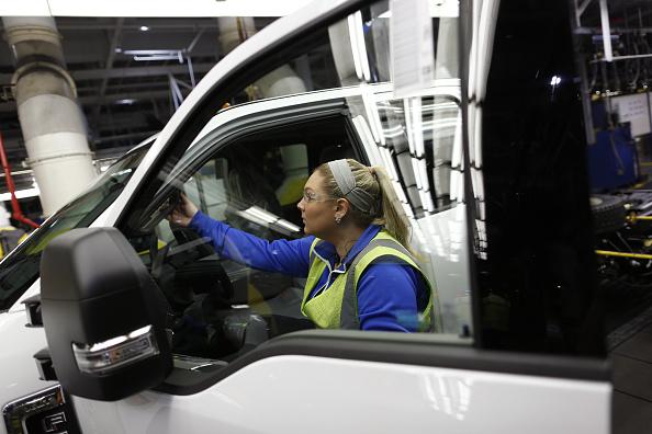 An employee climbs into a Ford Motor Co Super Duty Truck on the assembly line at the Ford Kentucky Truck Plant in Louisville, Kentucky, on Friday, 30 September, 2016.