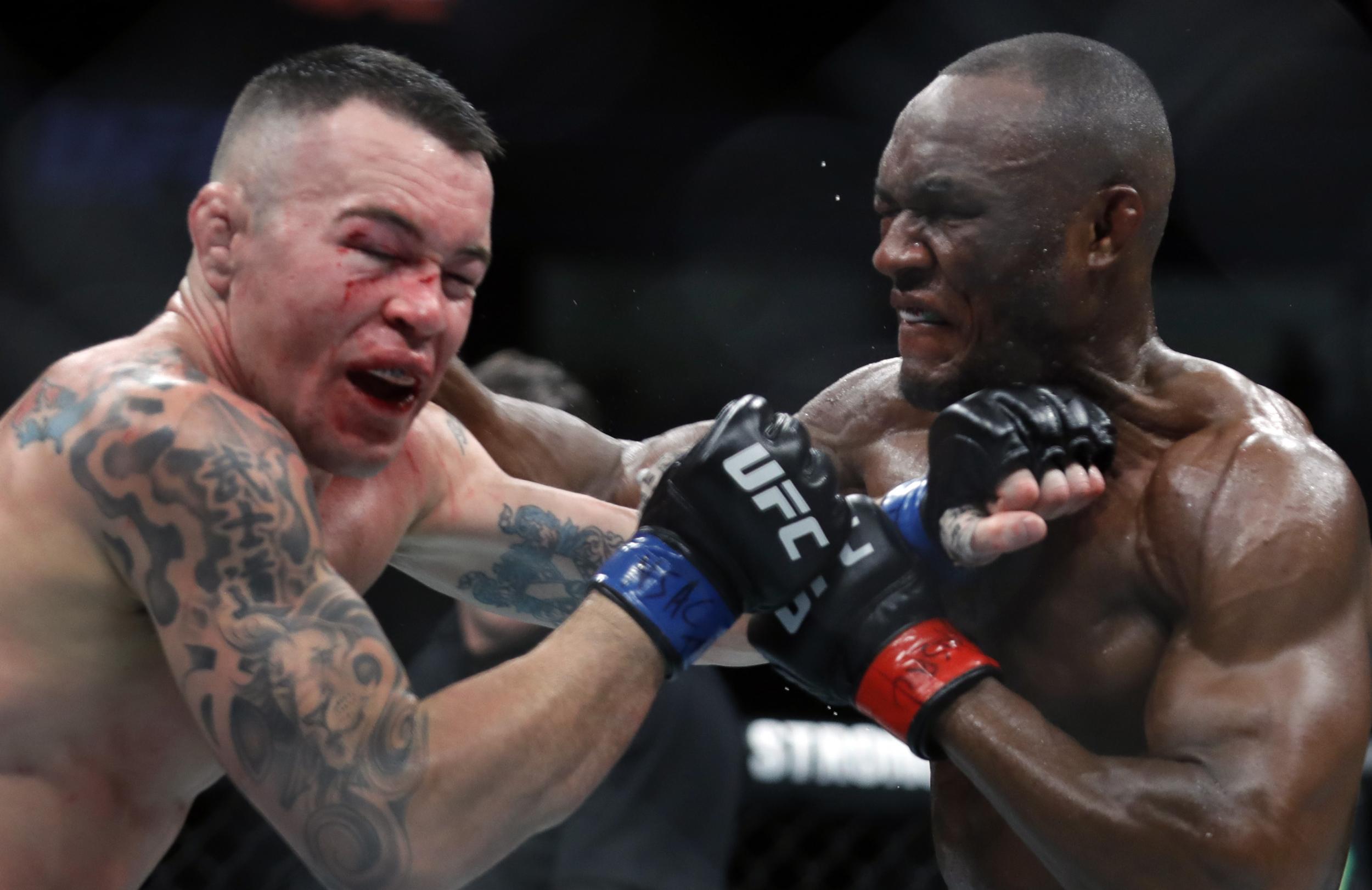 Kamaru Usman (right) finished Colby Covington late in the pair's UFC 245 main event to retain the welterweight title.