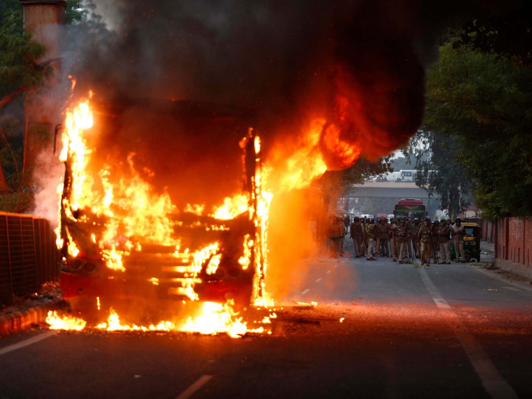 A passenger bus goes up in flames during a protest against Citizenship Amendment Act in New Delhi, India