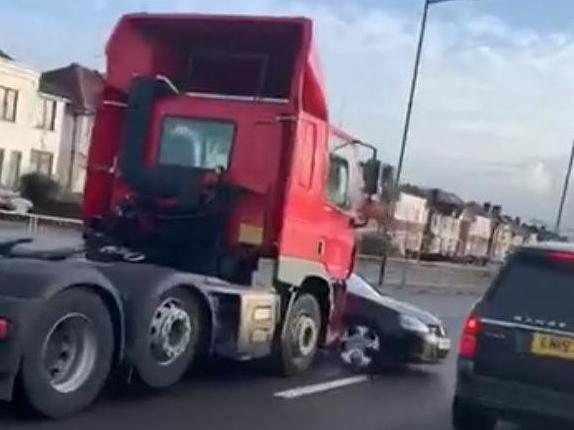 Witnesses said the car had been pushed along by the lorry for around a mile before it was flagged down