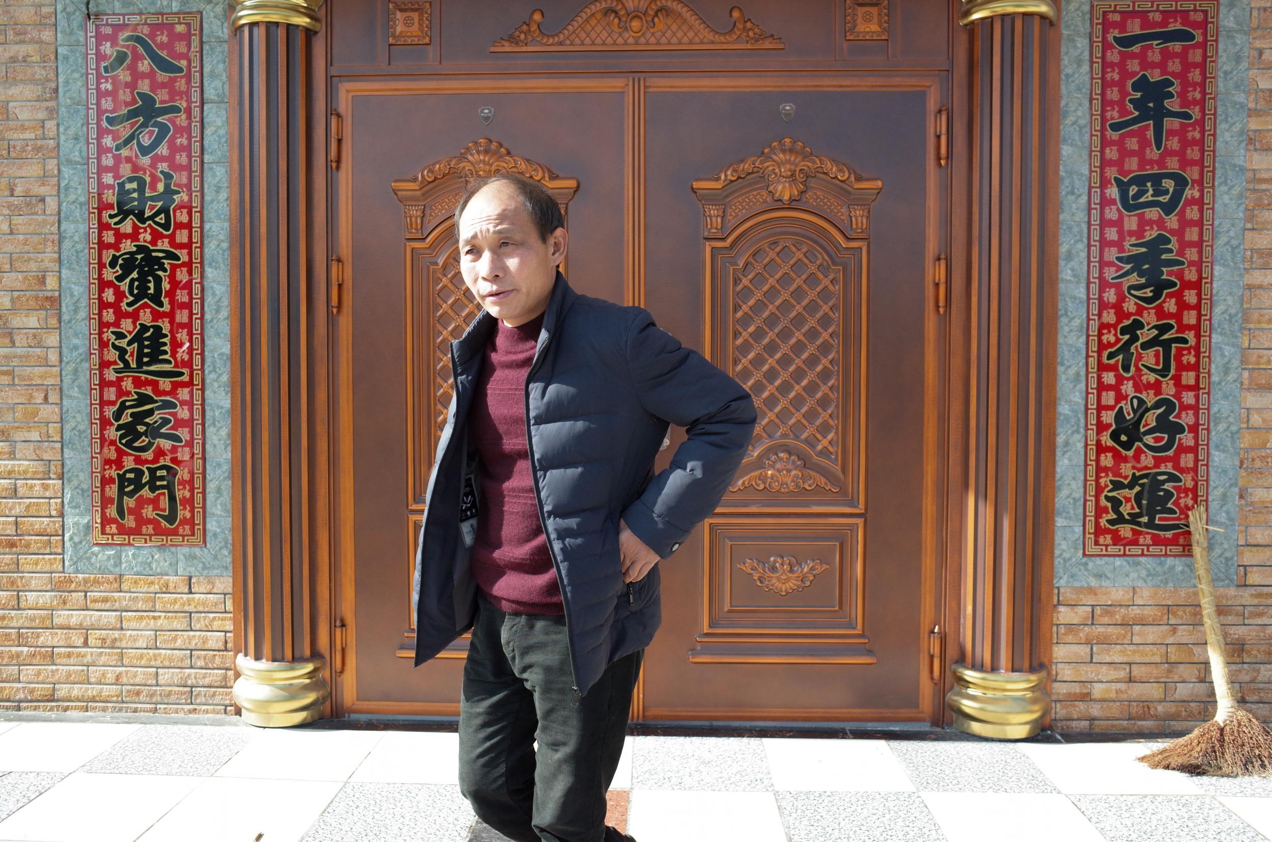 Xu Chunlin first travelled to Shenzhen in 1989 and introduced other Hunan villagers to construction jobs there. He made a relative fortune and lives in a three-story brick home with brass doors (The Washington Post/Gerry Shih)