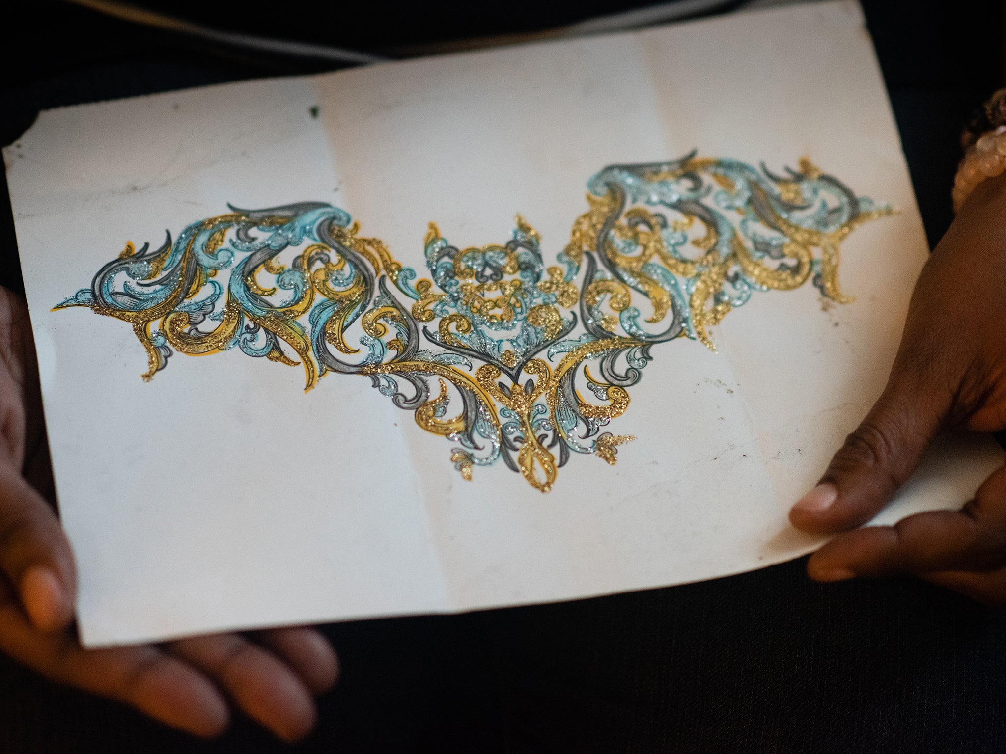 Ms Taylor holds artwork Kizer created and mailed to her from prison