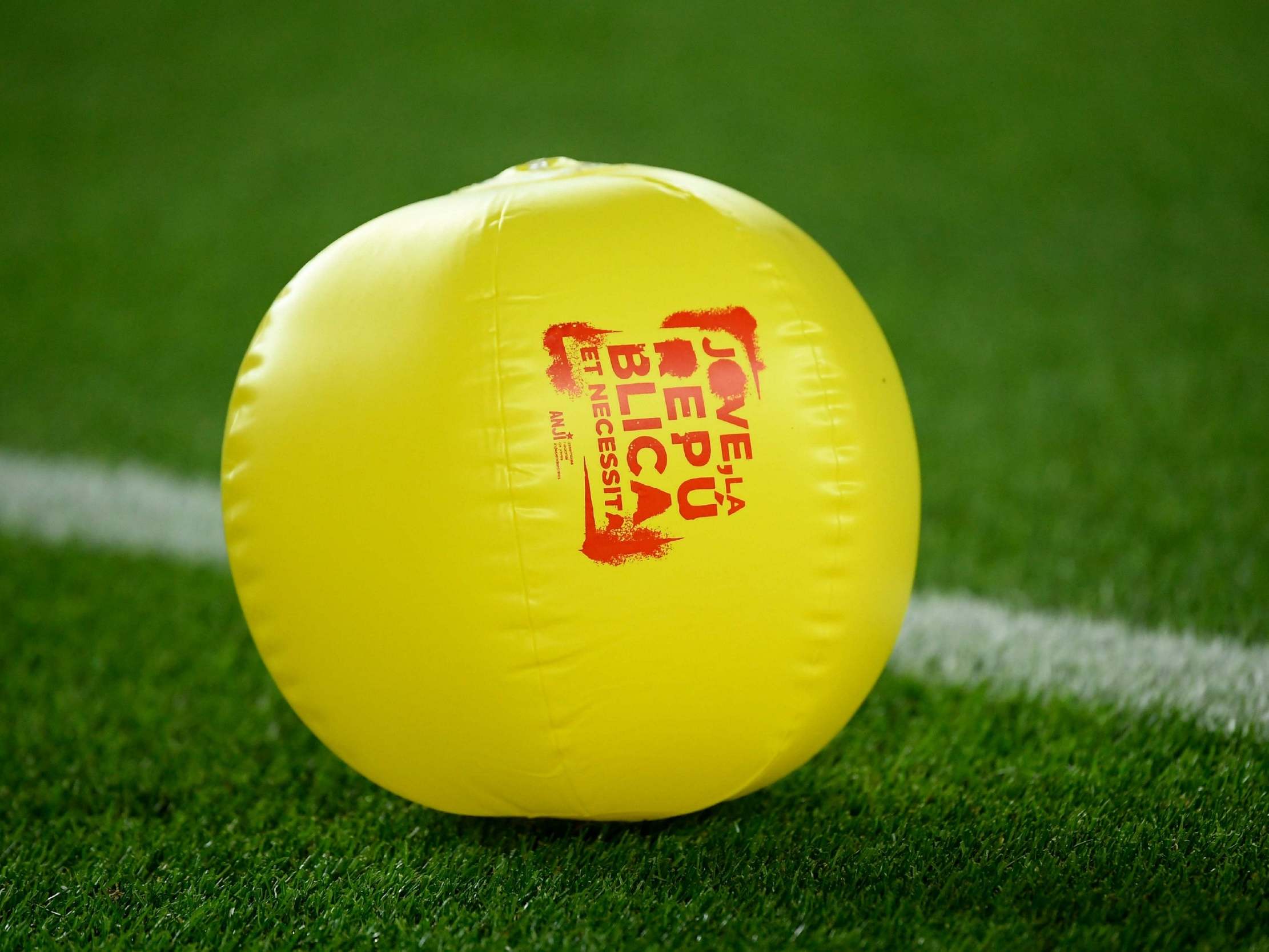 A yellow balloon reading "Youngster, the republic needs you" thrown onto the Nou Camp pitch