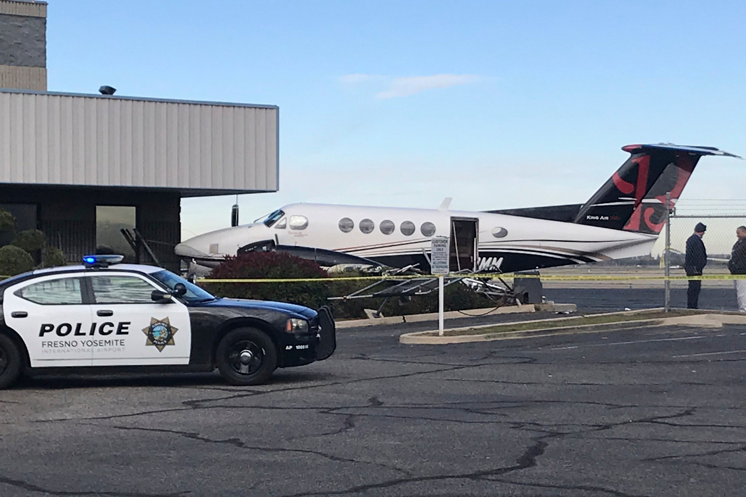 A small plane sits parked after it was crashed into a fence by a 17-year-old girl