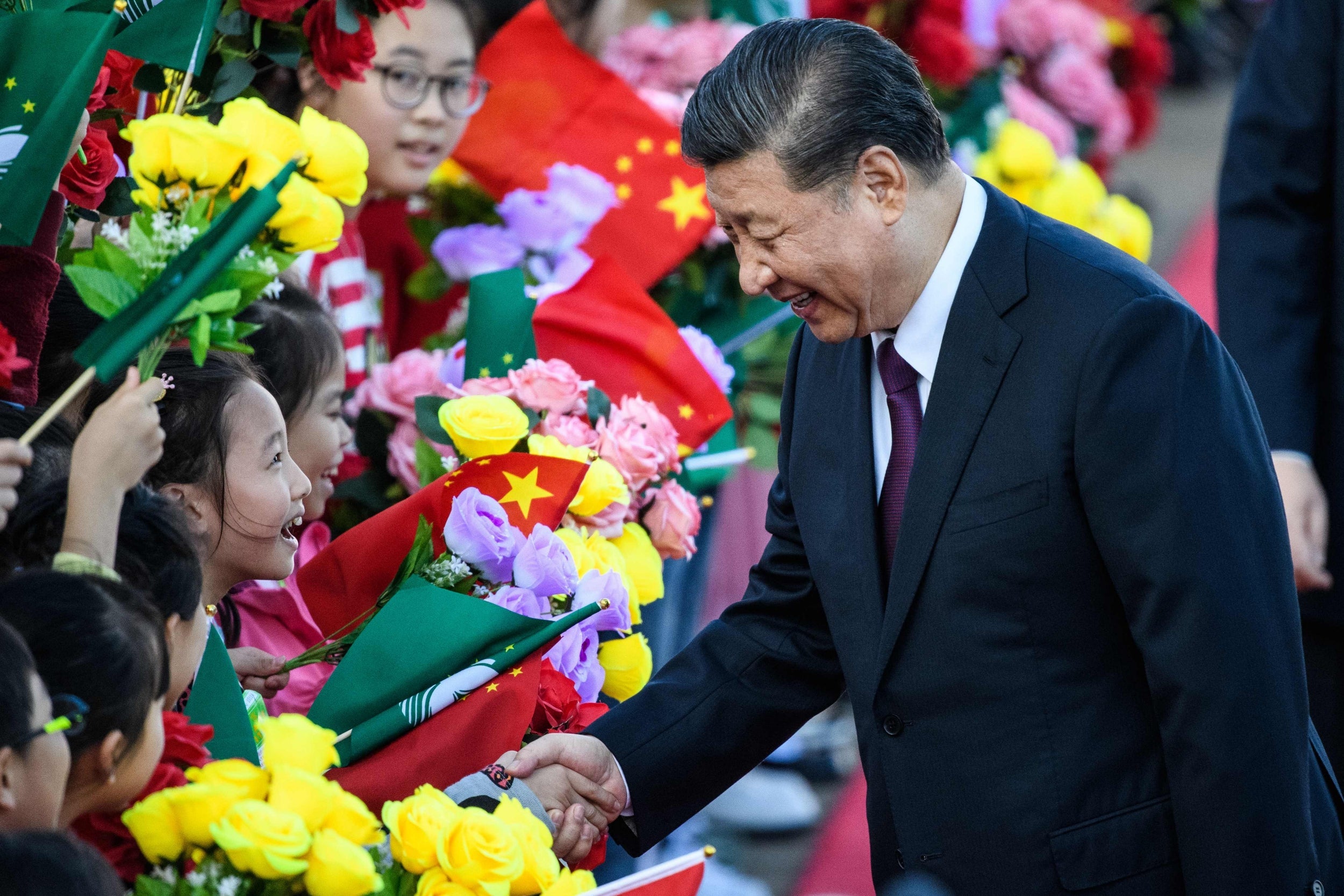 President Xi Jinping shakes hands with a girl as she and other children welcome Xi upon his arrival to Macau on Wednesday (AFP/Getty)