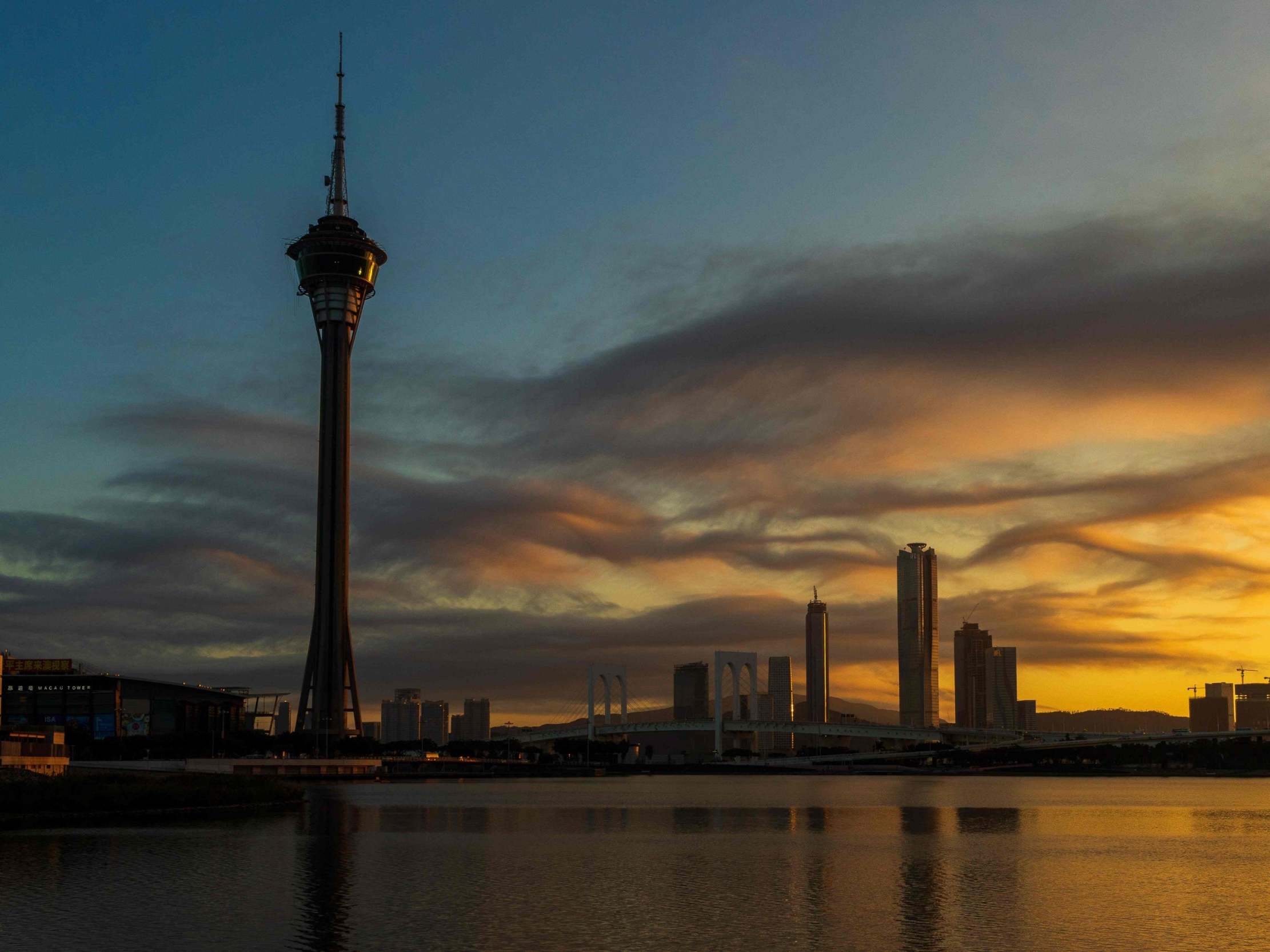 The sun sets behind the Macau Tower and skyline (AFP/Getty)