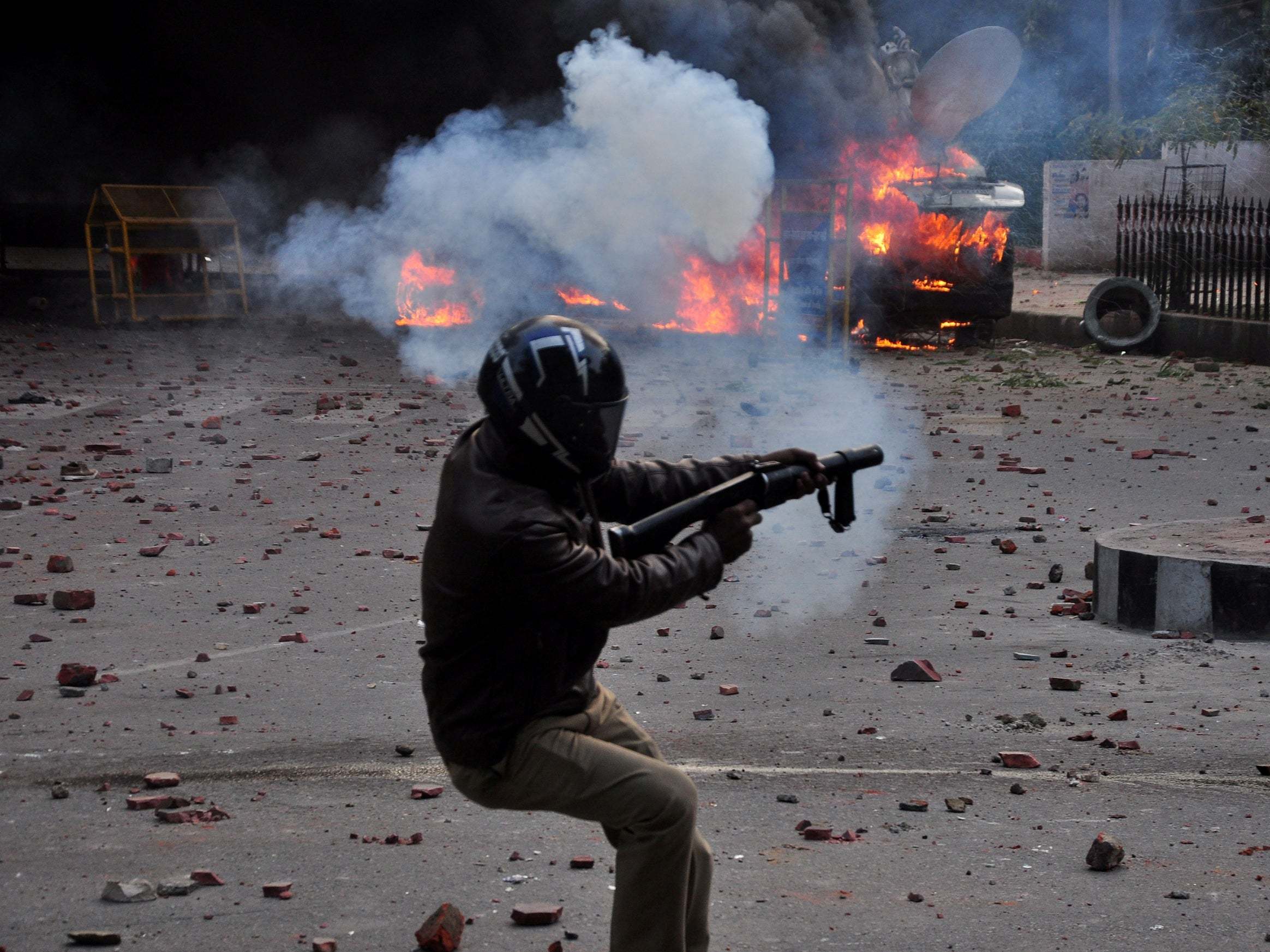 A policeman fires a teargas shell towards demonstrators during a protest against a new citizenship law, in Lucknow, India, 19 December, 2019.