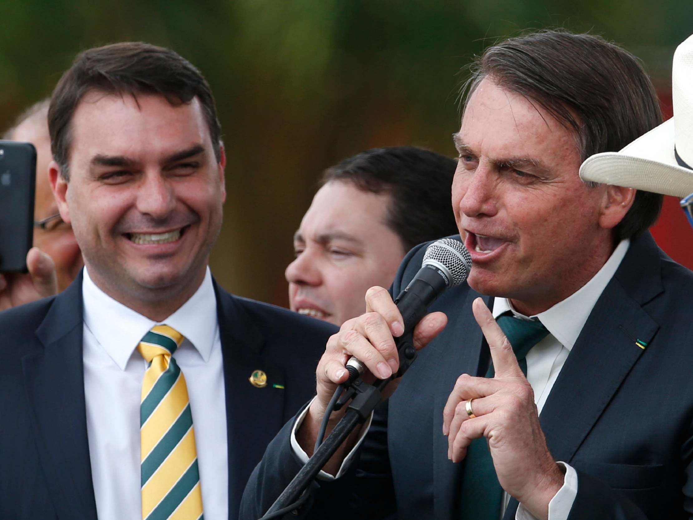 Accompanied by his son Flavio Bolsonaro, Jair Bolsonaro, Brazil's president, speaks at the launch of his new political party