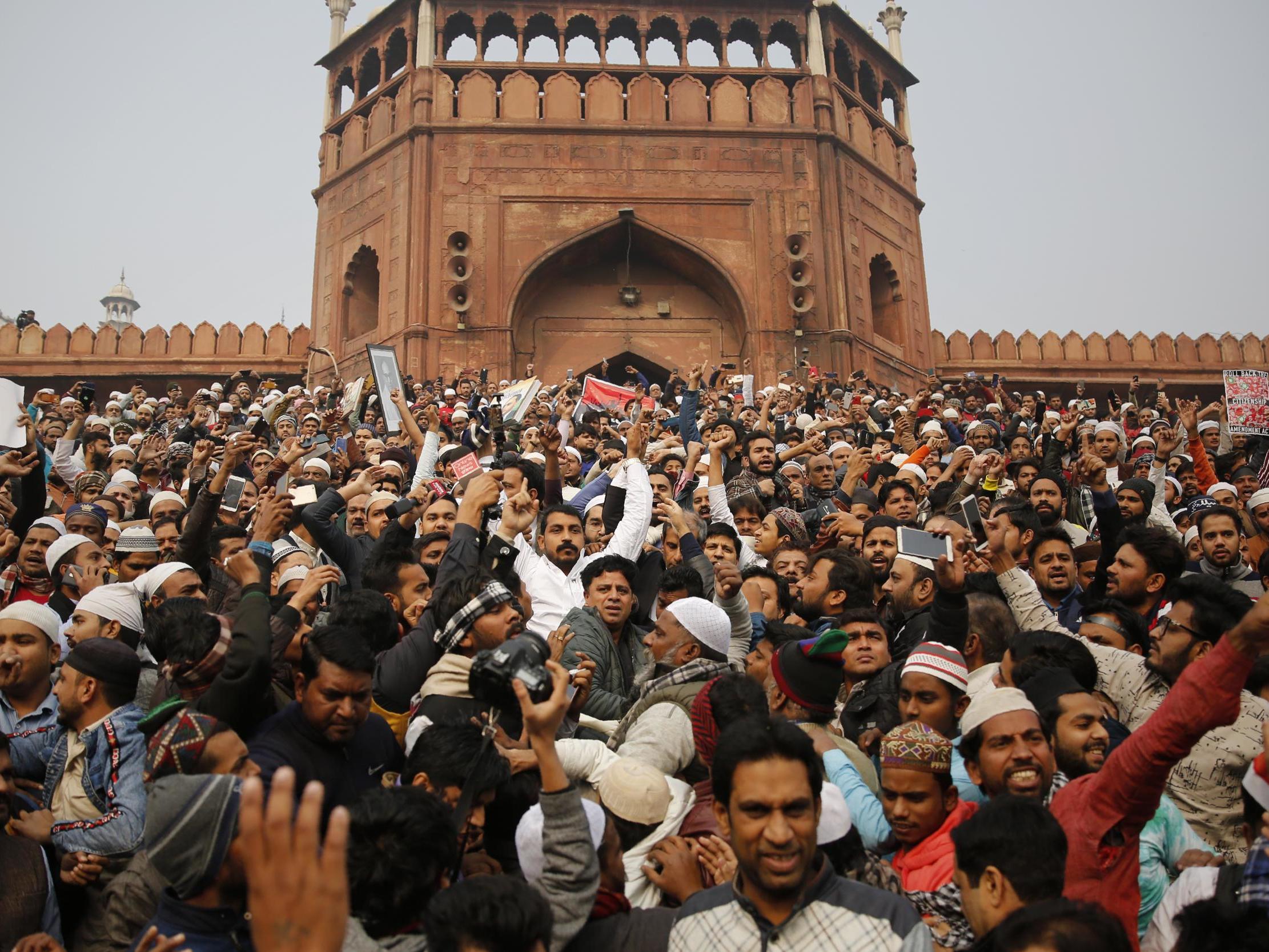 Dalit leader and Bhim Army founder Chandrashekhar Azad, center in white, join others for a protest against the Citizenship Amendment Act after Friday prayers outside Jama Masjid in New Delhi