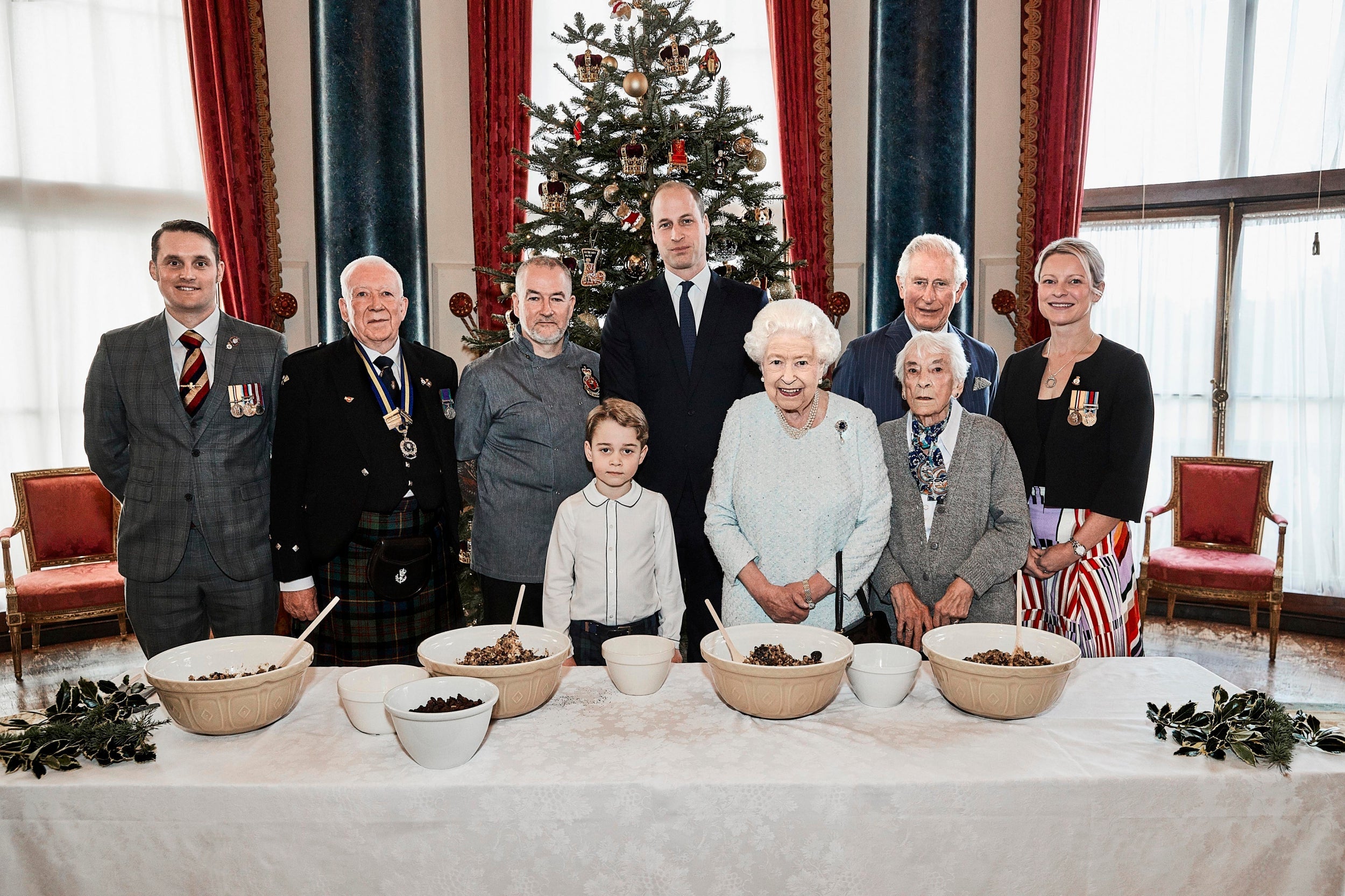 Queen Elizabeth II, the Prince of Wales, the Duke of Cambridge and Prince George, alongside (left to right) veterans Liam Young, Colin Hughes, Alex Cavaliere, Barbra Hurman and Lisa Evans, in the Music Room at Buckingham Palace, London.