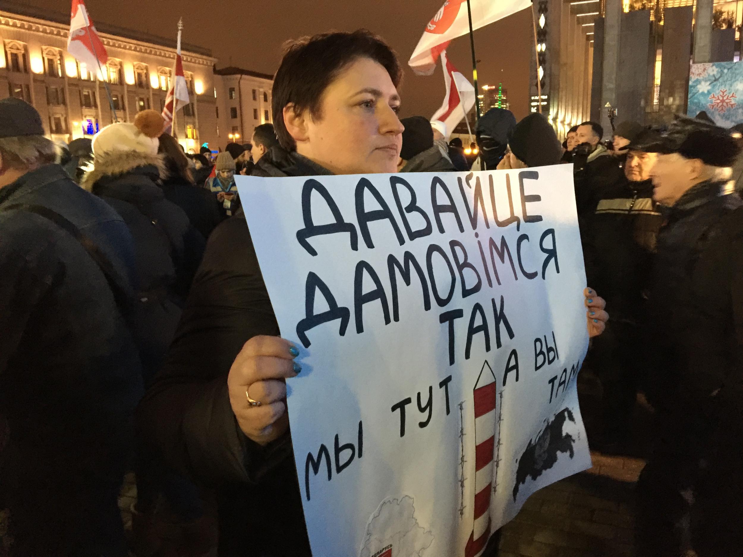 Economist Svetlana Kovalenko holds a sign at a rally against integration with Russia. “Let’s do a deal,” it reads. “We stay here and you stay there.” (Oliver Carroll/The Independent)