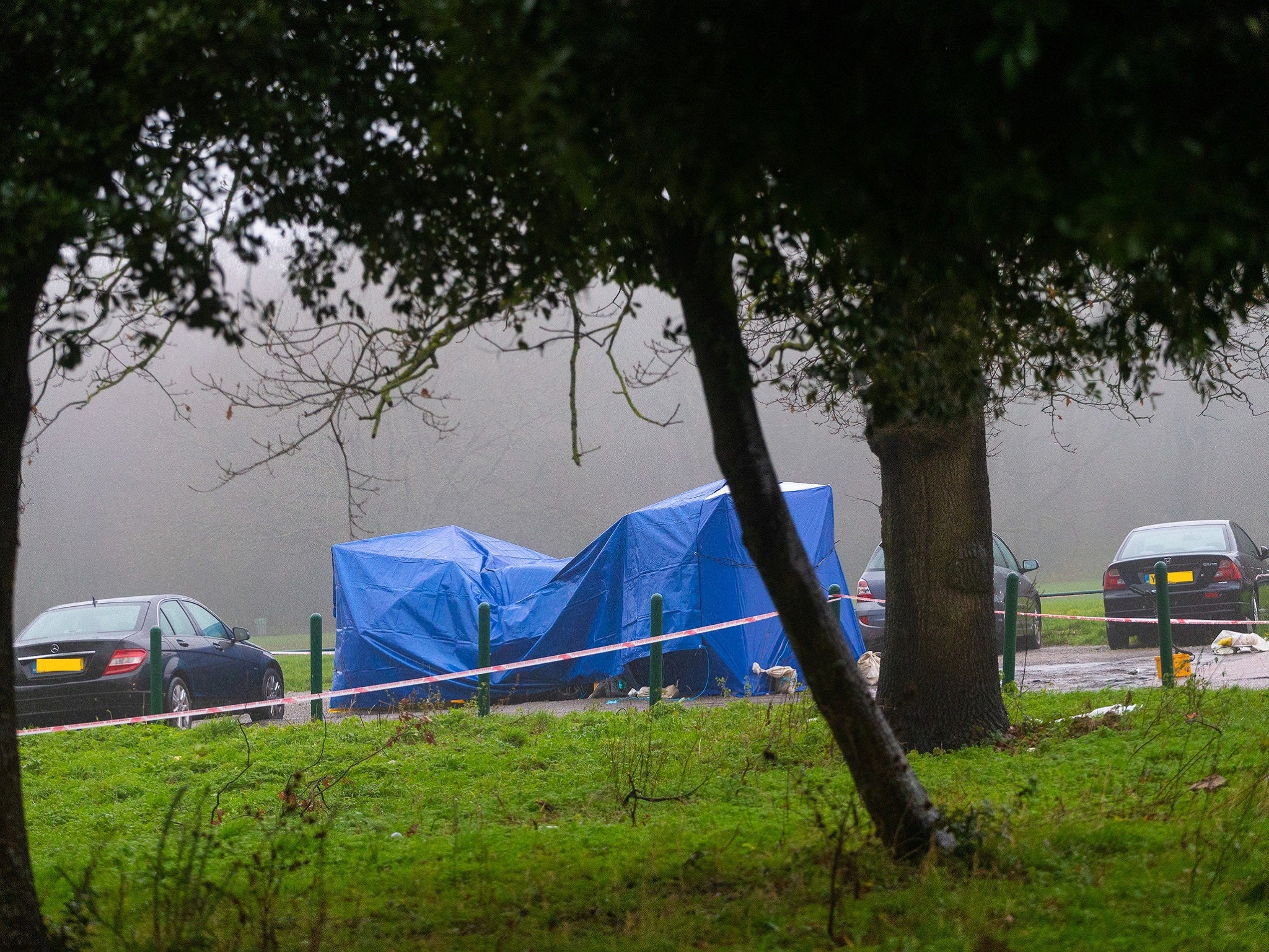 A forensic tent covers a car in Scratchwood Park off Barnet Bypass, north London, after police found a man stabbed to death inside the boot on 19 November, 2019.
