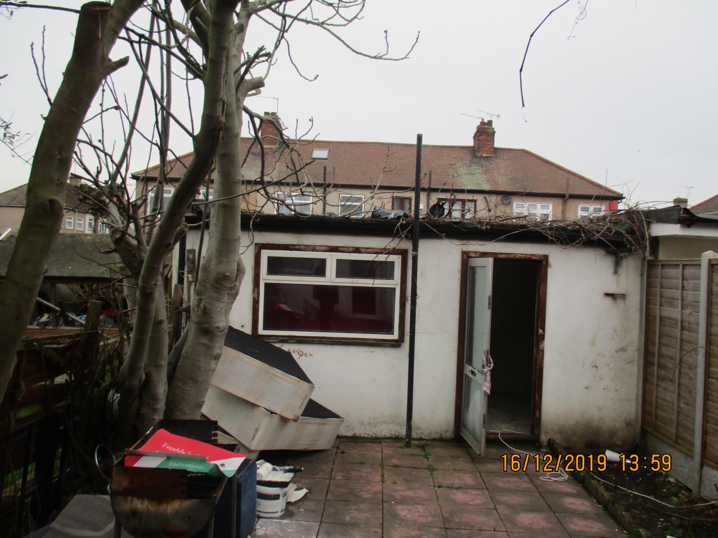 More than 25 people were thought to be living in the main building in Albert Close, while two were in an illegal makeshift shed in the garden