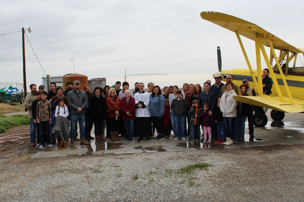 Parishioners brought water from their home to be blessed and loaded onto the plane