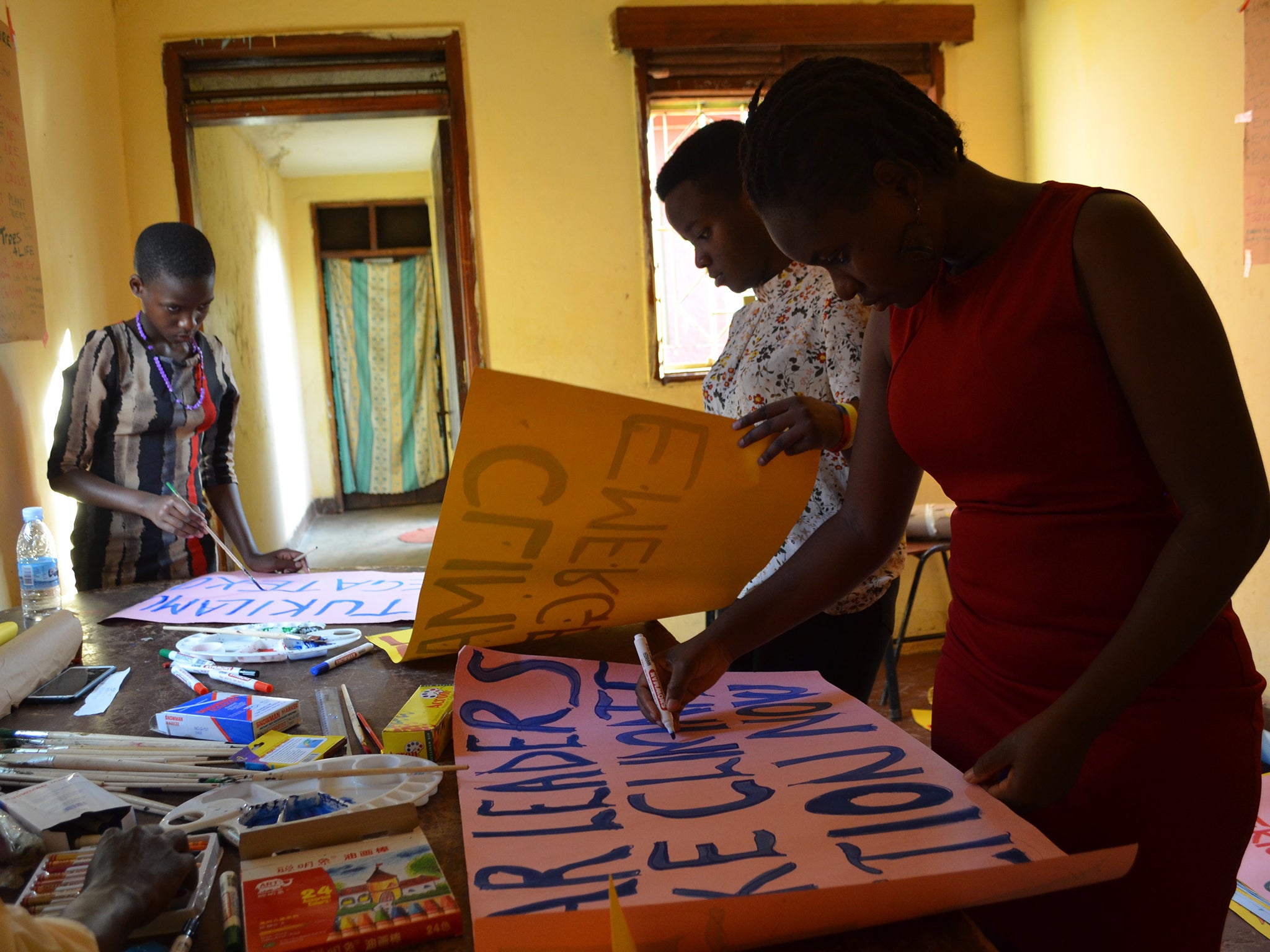 Namugerwa, making protest signs, says: ‘At least if the leaders can’t make a difference, we can make a difference. We, as kids, we’re not too young to make a positive difference’