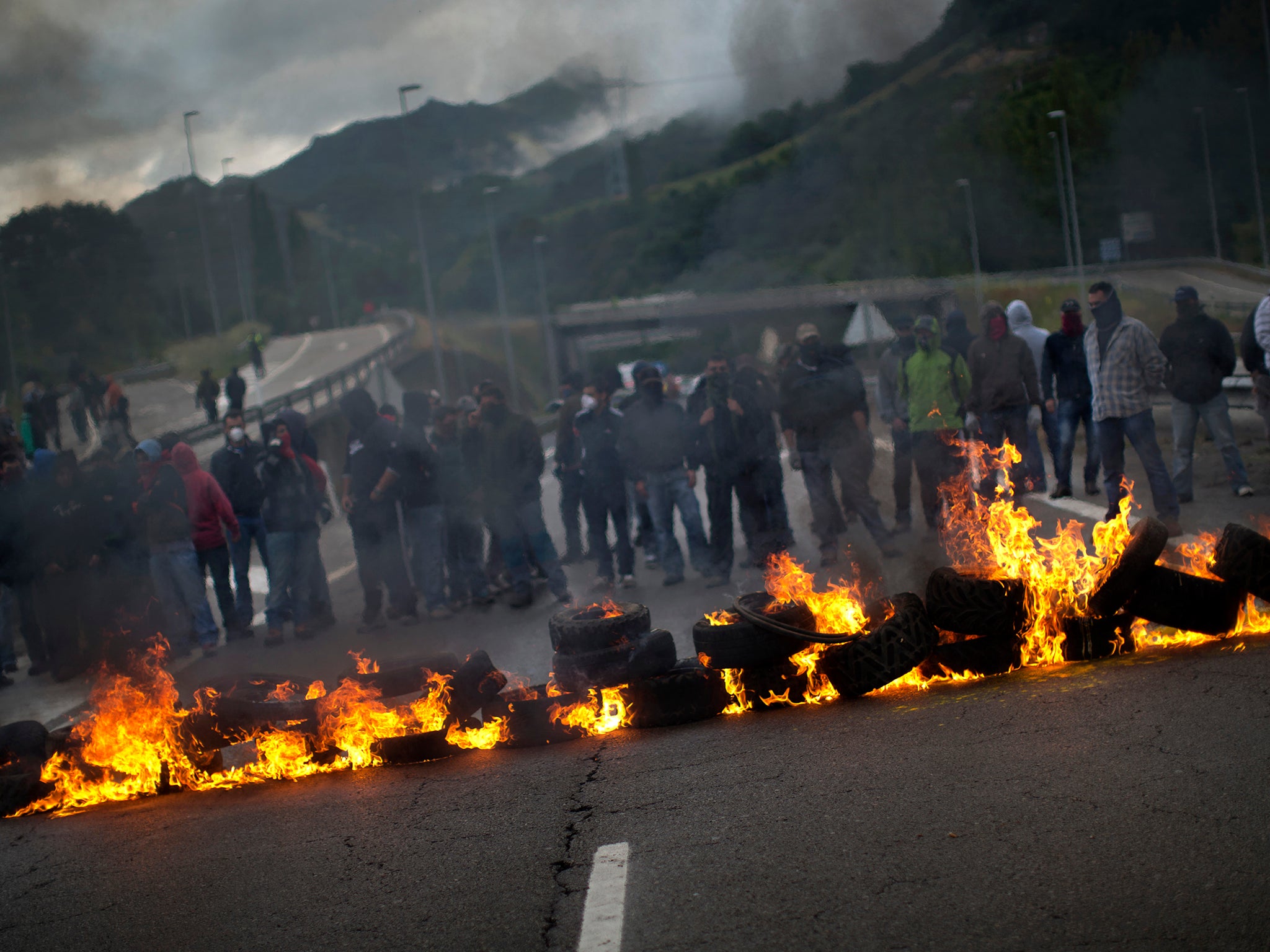 Demonstrators block a motorway in protest of government plans to scale back mining in 2012