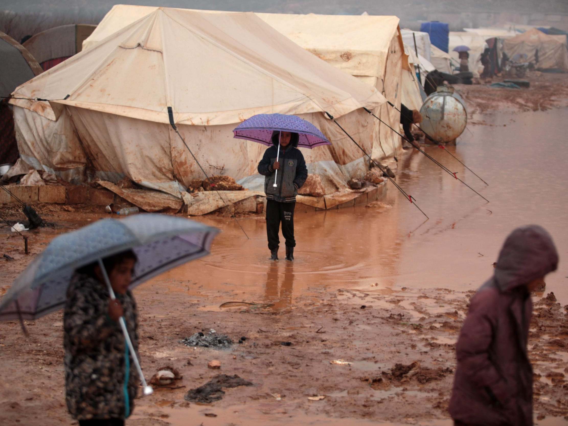 Syrian children in a camp for displaced people in Kafr Dariyan, a short distance from Syria’s border with Turkey, on 28 December 2019 (AFP via Getty)