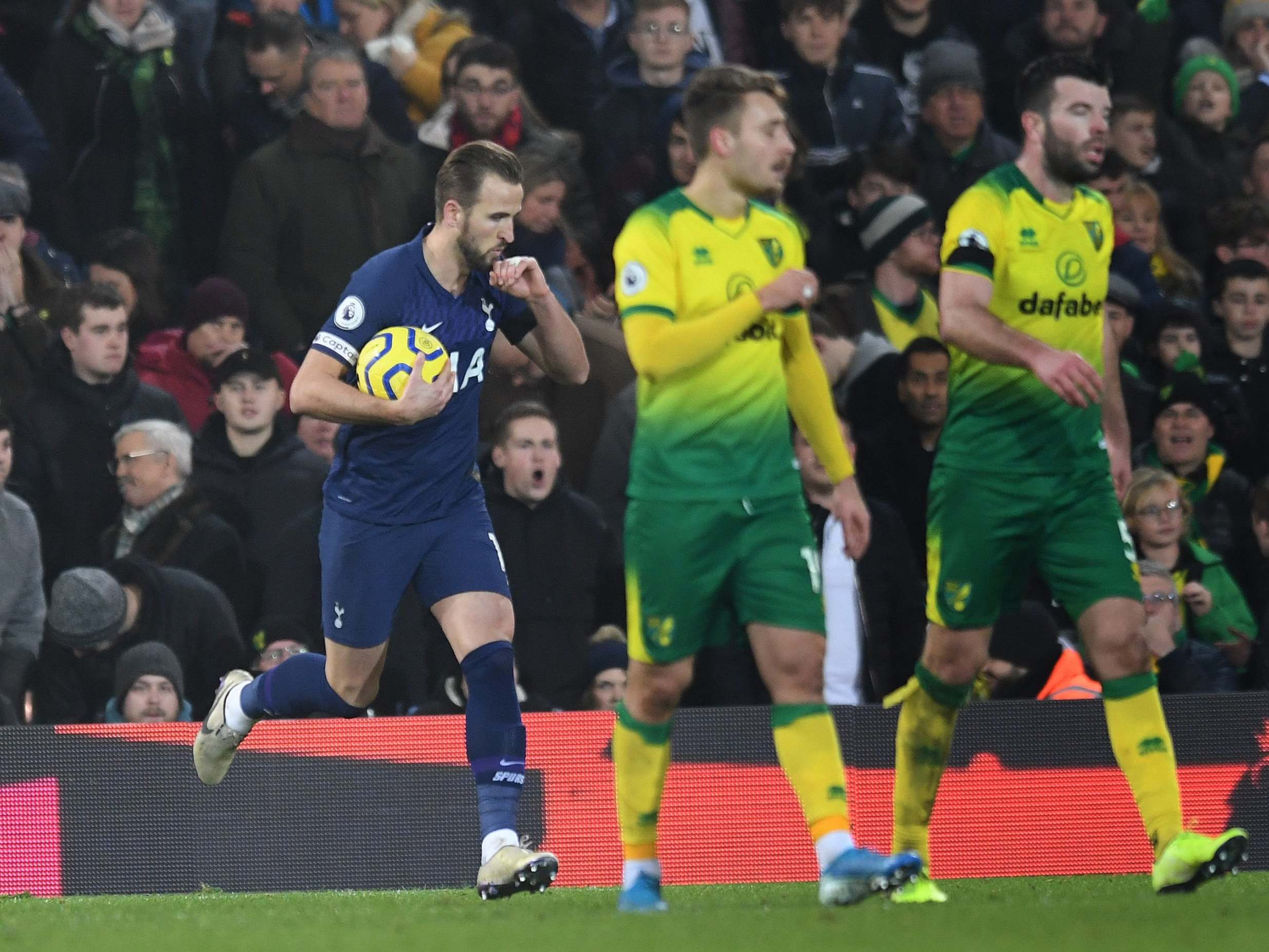 Harry Kane celebrates his late penalty to earn a draw at Norwich