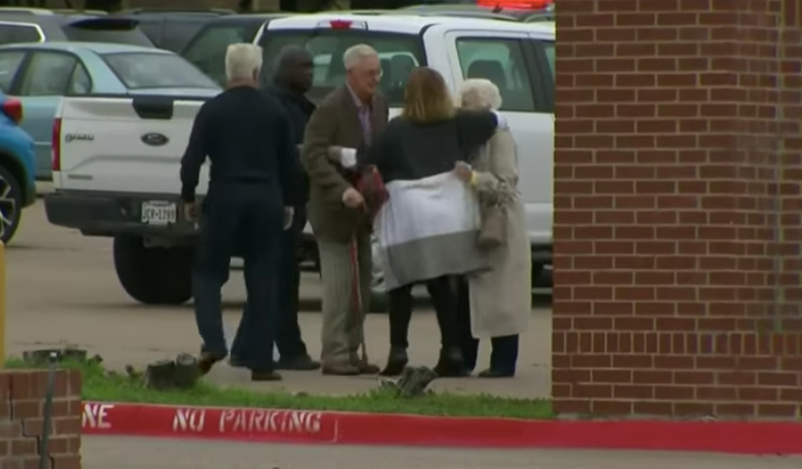 People could be seen comforting each other outside the church following the shooting