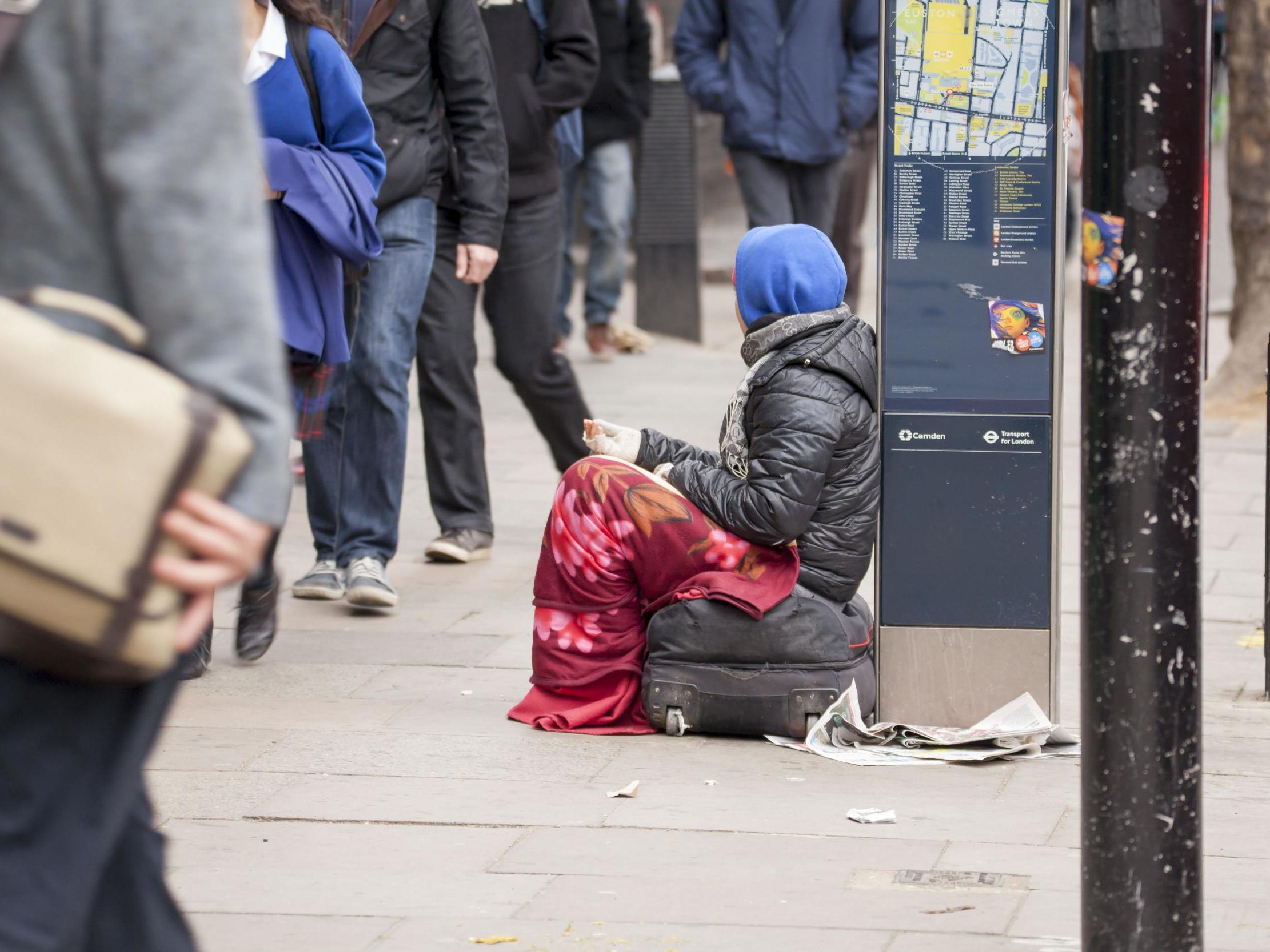 Two police officers posed with cardboard signs confiscated from beggars