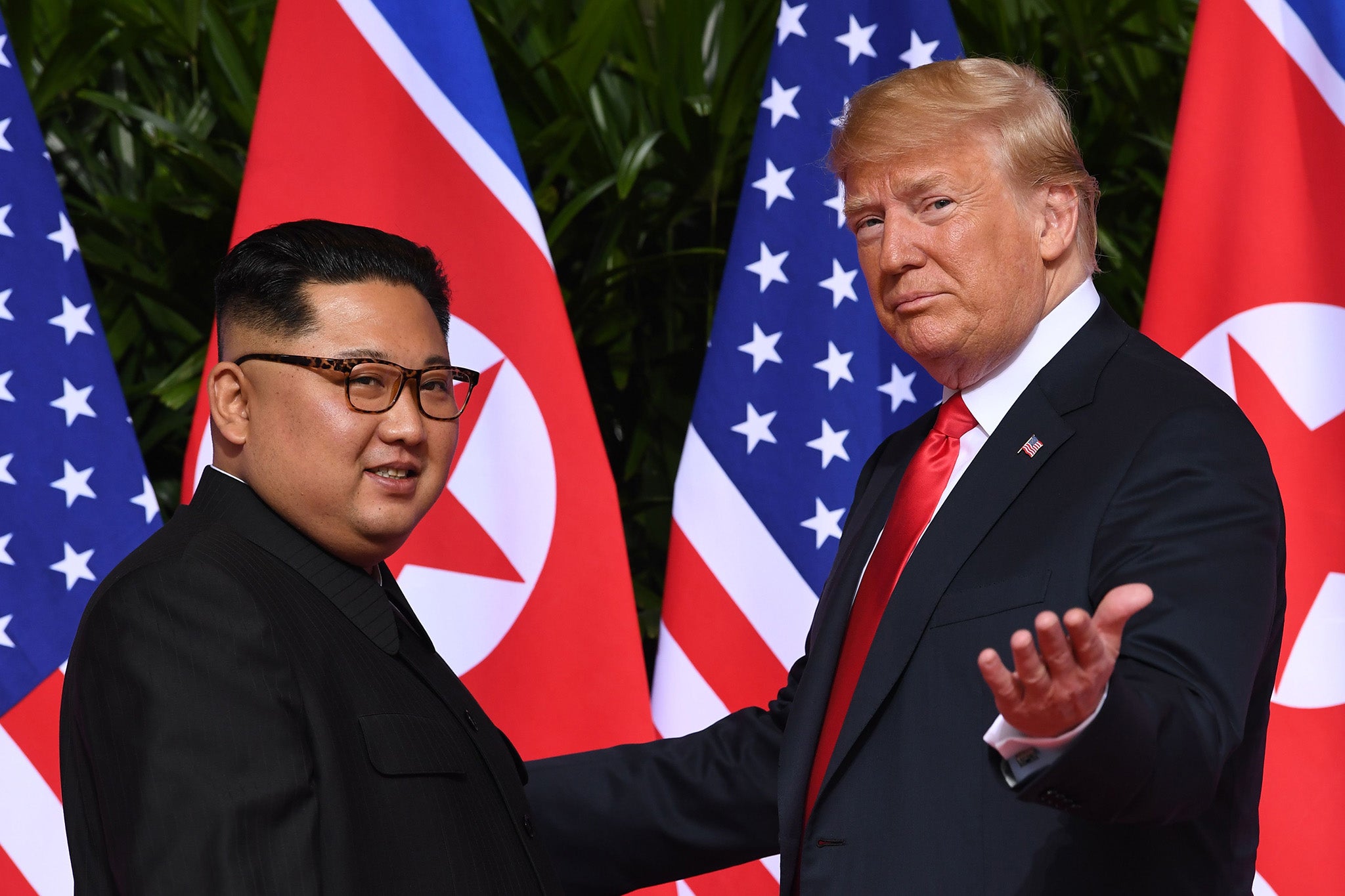 The US president meets with North Korea’s supreme leader at the start of the summit on Sentosa island on 12 June 2018