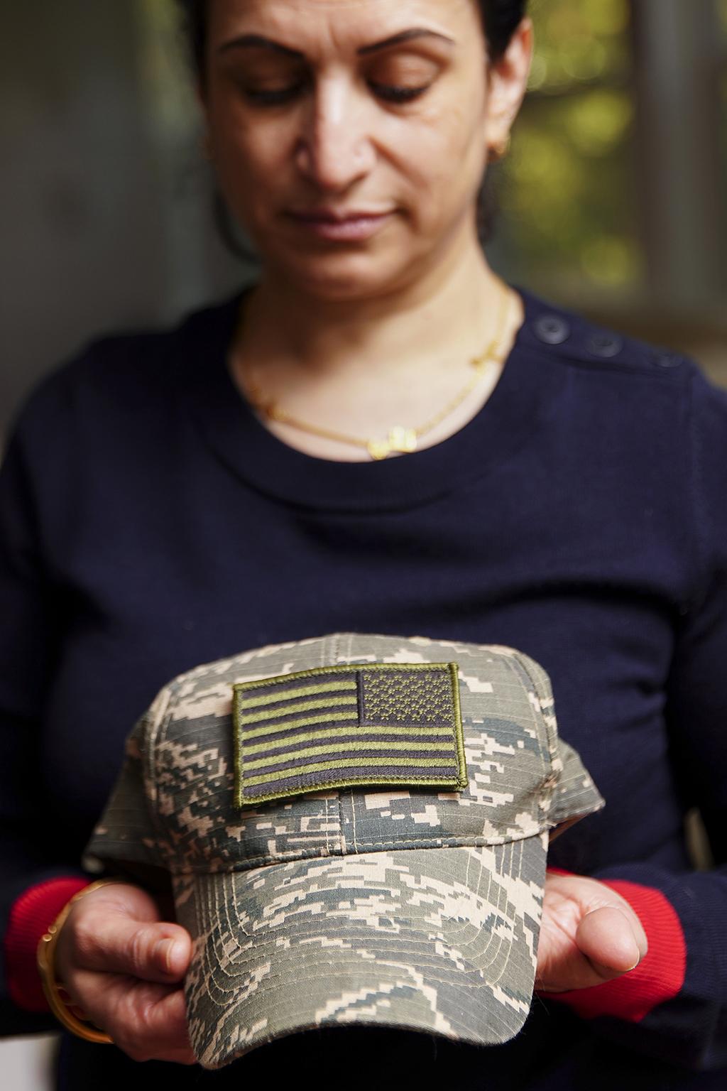 Amina Shaheen holds a hat belonging to her daughter, Ghadir Taher (Elijah Nouvelage/Washington Post)