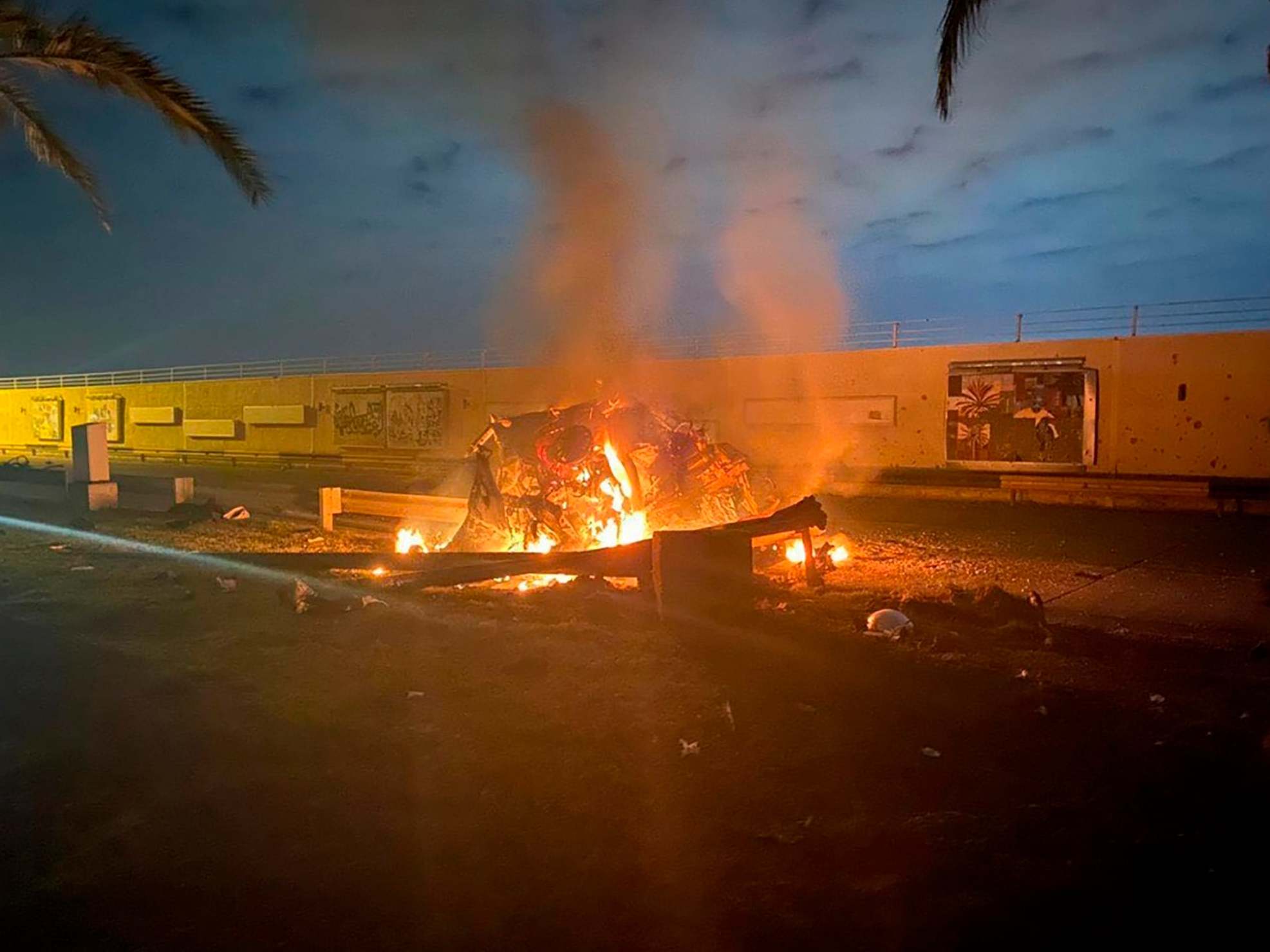 Images released by an official Iraqi press office show a burning vehicle at Baghdad International Airport