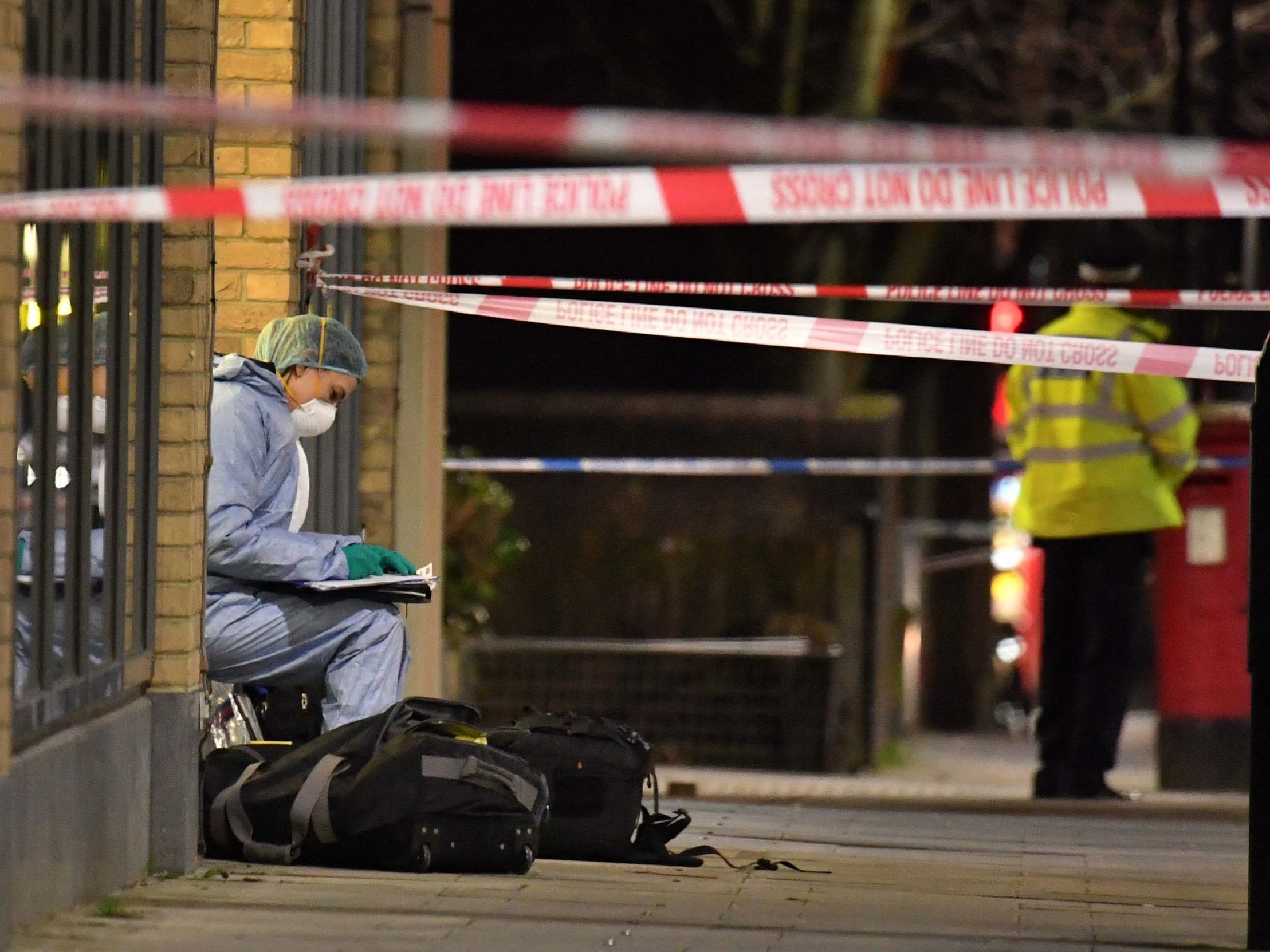 Forensic officers at the crime scene in Finsbury Park after a man was stabbed to death on Friday evening