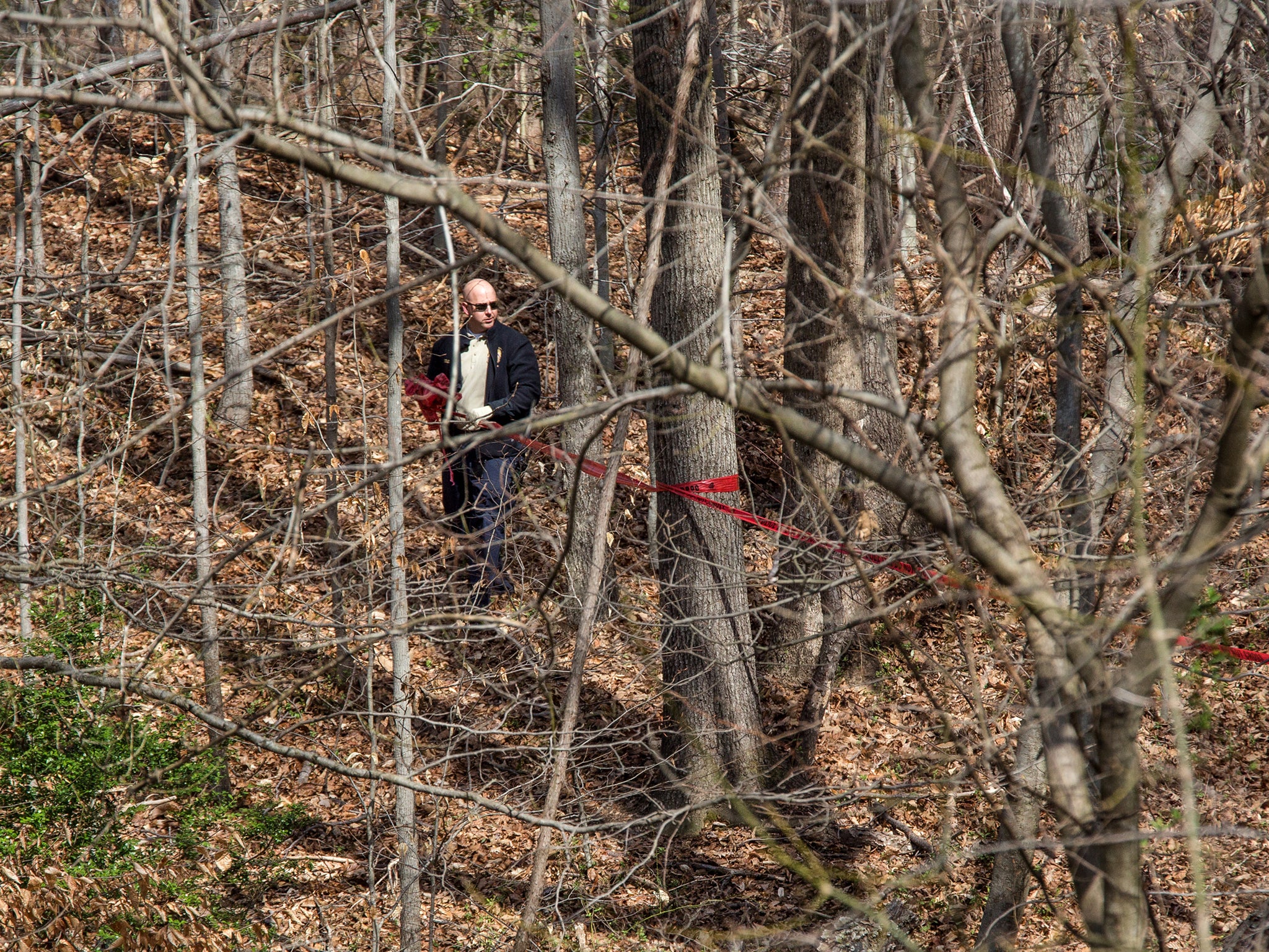 Police remove crime scene tape on where two bodies were found in Holmes Run Park