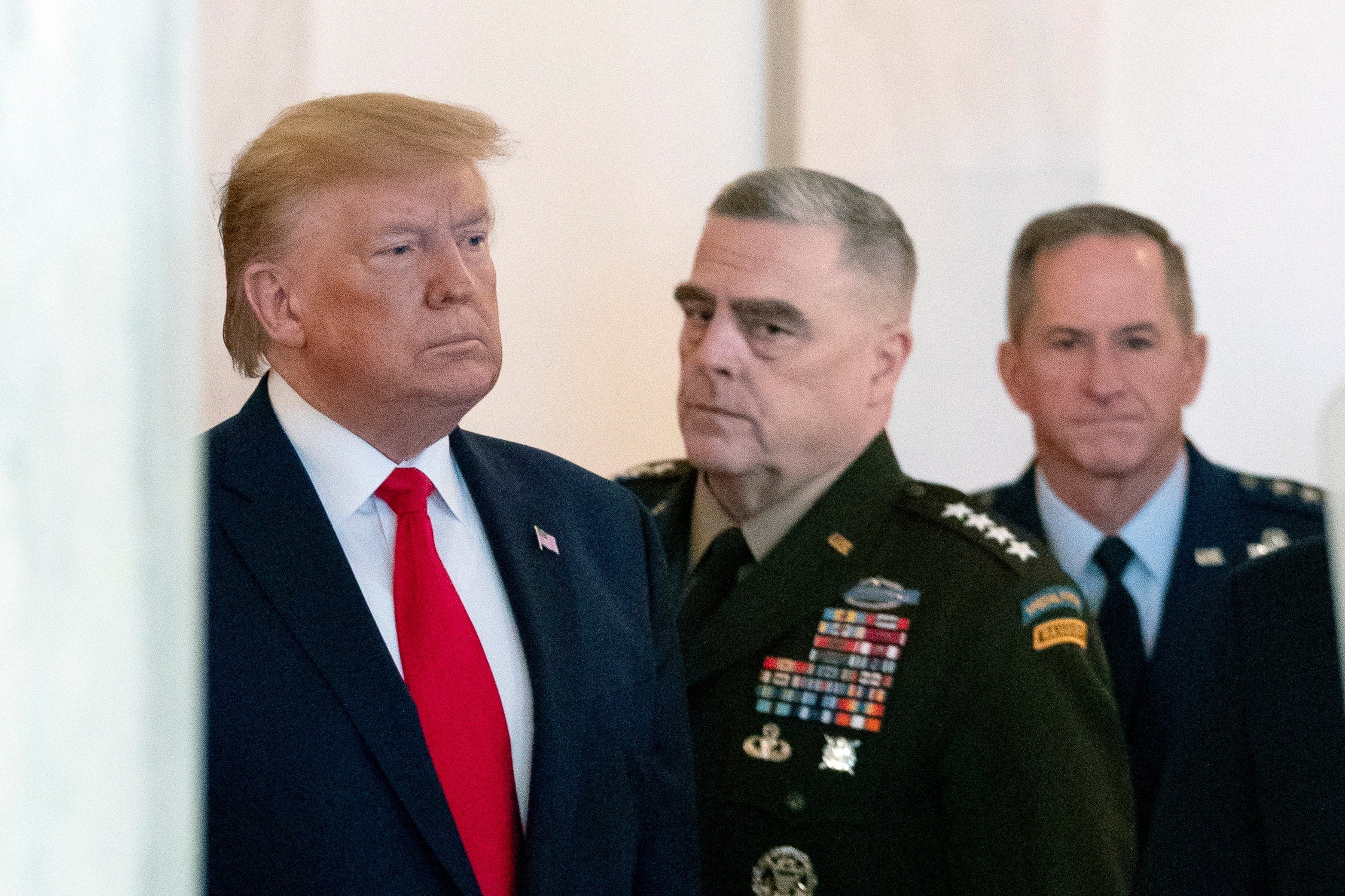 Donald Trump, with Mark Milley, chairman of the joint chiefs of staff, centre, and David Goldfein, Air Force chief of staff, right, prepares to read a statement on tensions with Iran