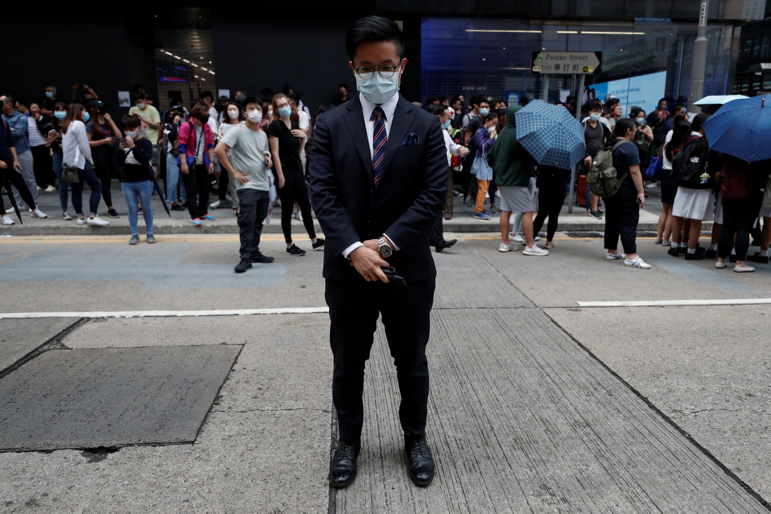 Jasper, 27, poses during a demonstration in Hong Kong