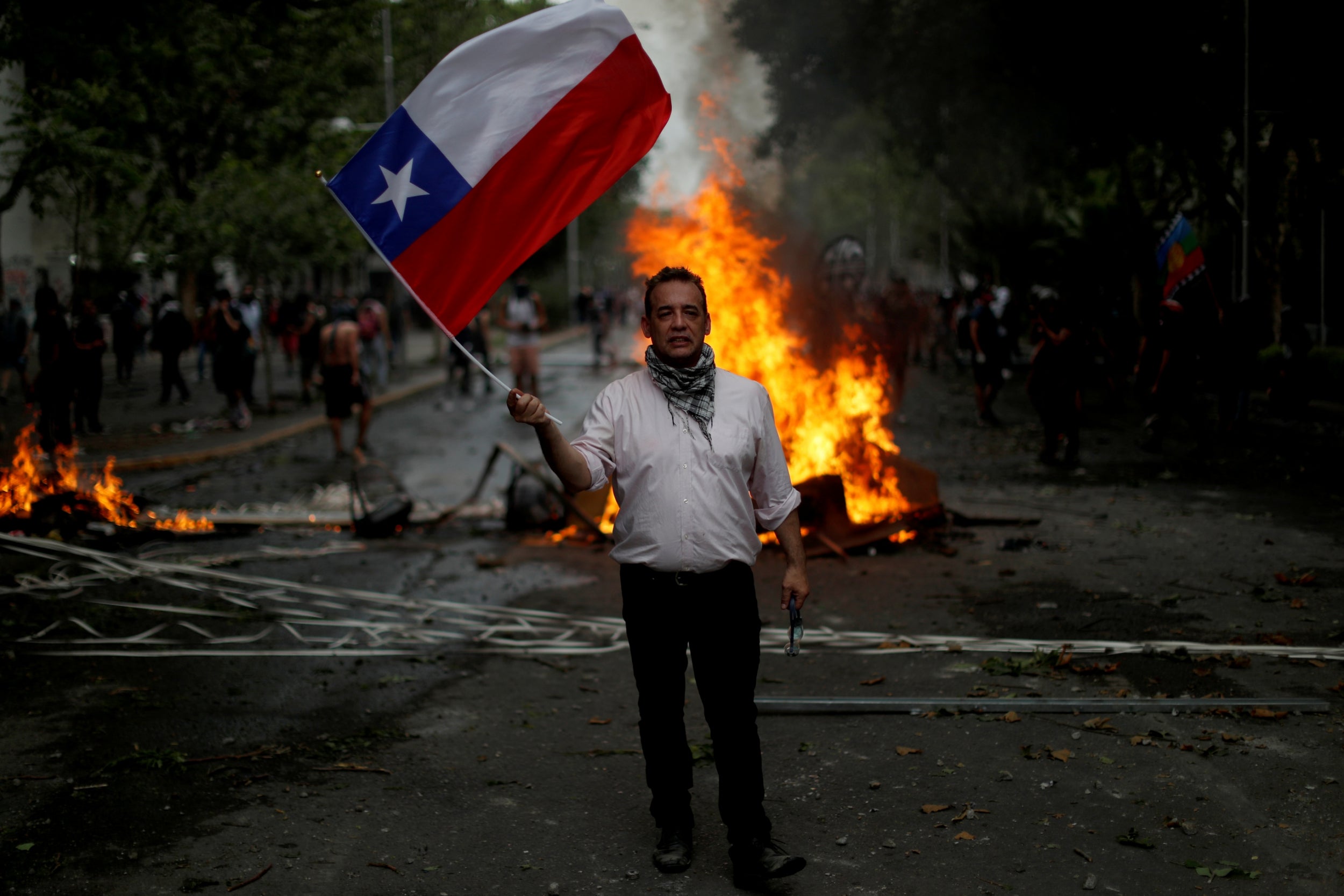 Alex Munoz Fuentes, 47, with a Chilean flag in Santiago, Chile