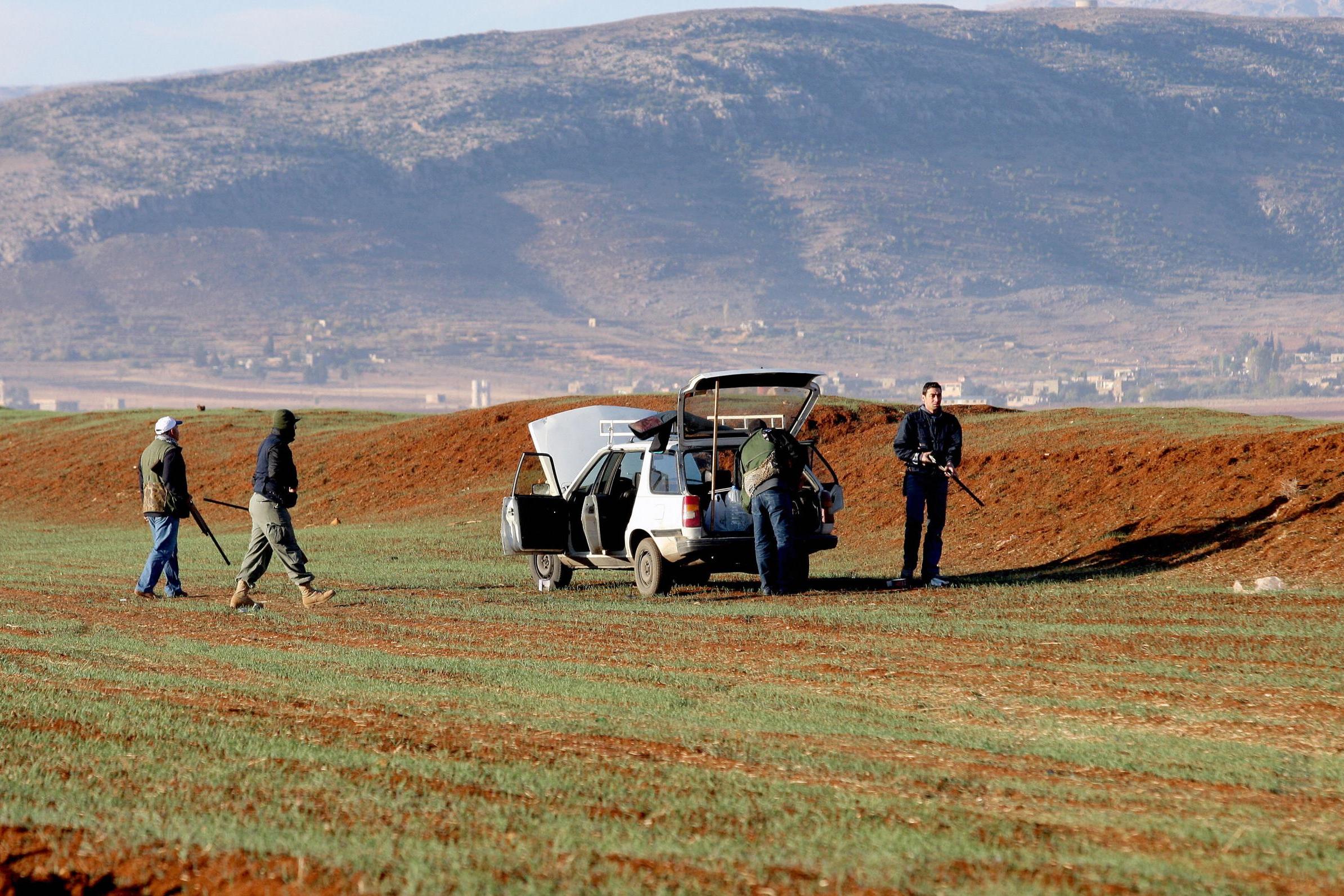 Lebanese bird hunters get ready to practise their sport on the outskirts of the village of Shlifa in Lebanon’s eastern Bekaa valley (Getty)