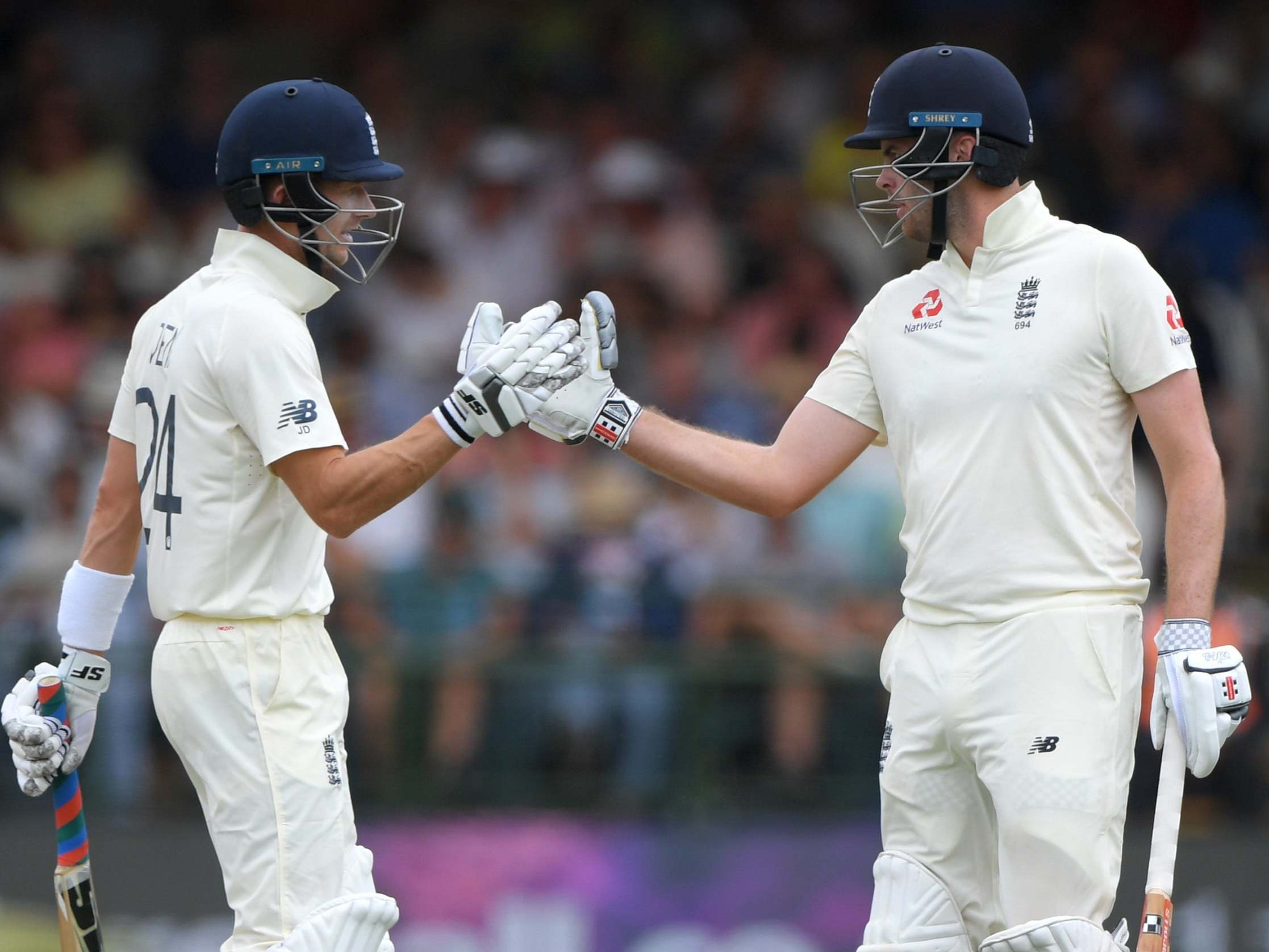 Joe Denly, left, and Dom Sibley celebrate their 50 partnership on day three at Newlands