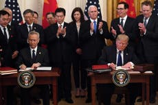 Trump signs 'landmark' first phase of China trade deal amid tariffs war