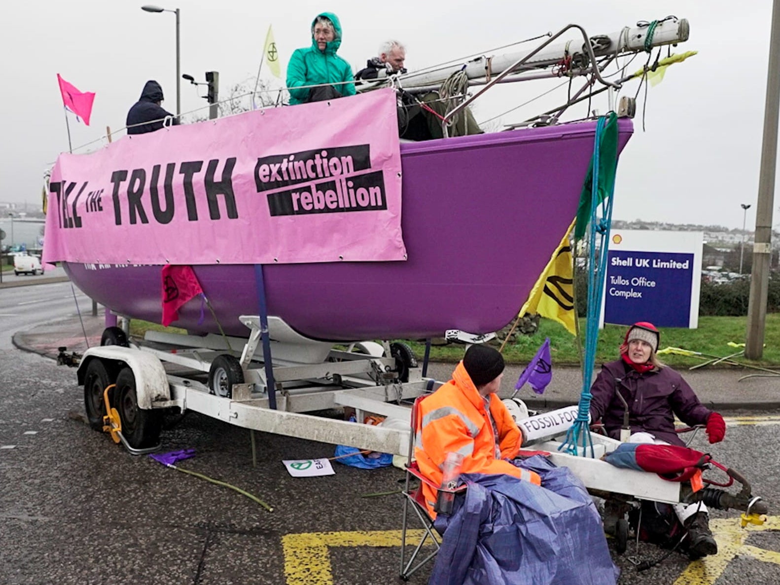 Extinction Rebellion (XR) members gather around the Amal Gous boat