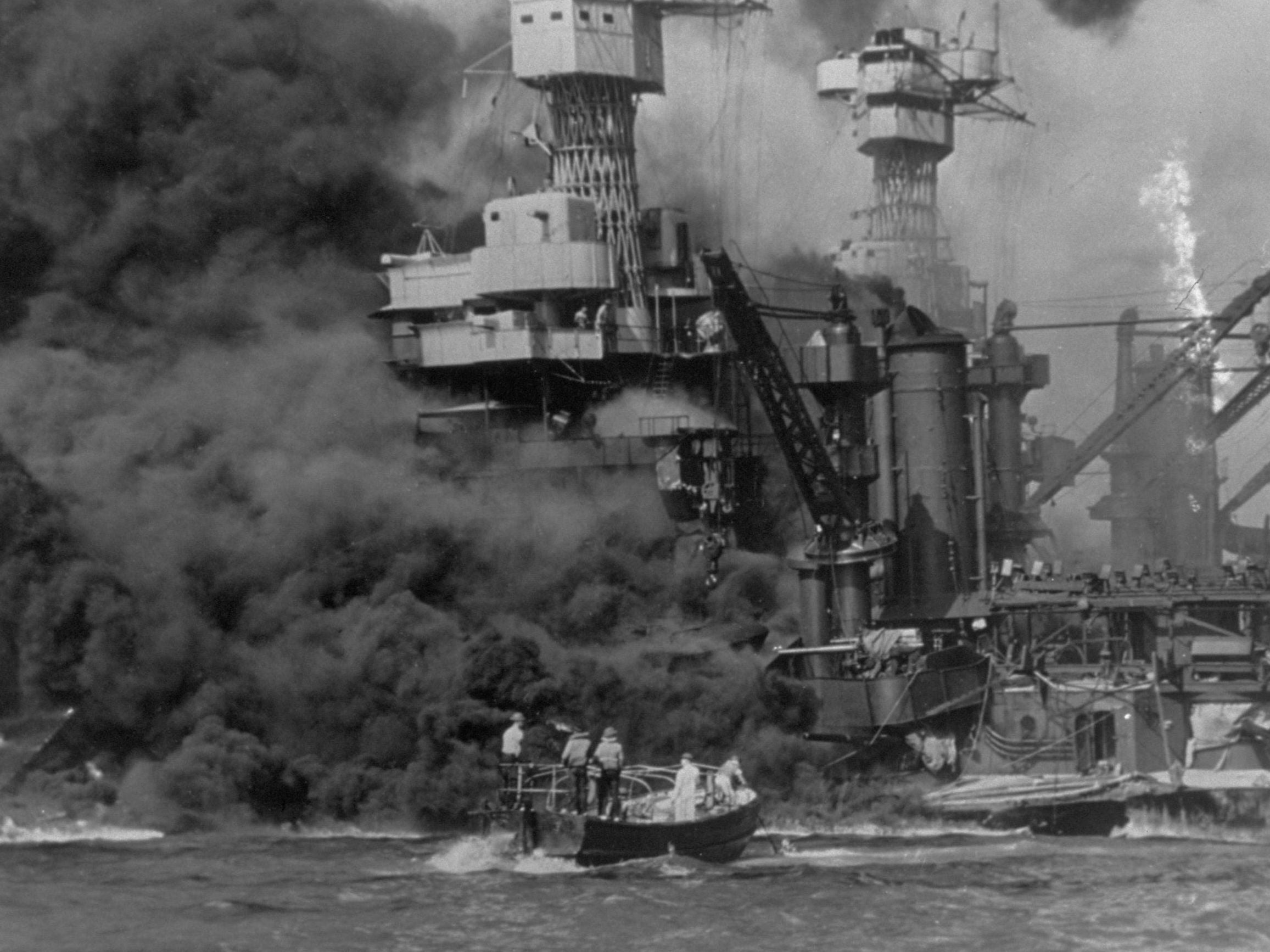 A small boat rescues sailors from the USS 'West Virginia', Doris Miller's ship, after she had suffered a hit