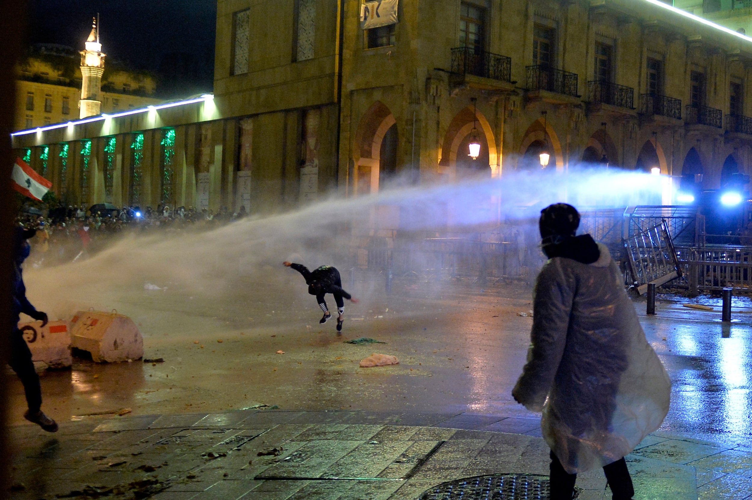 Lebanese riot police spray water at protesters in Beirut