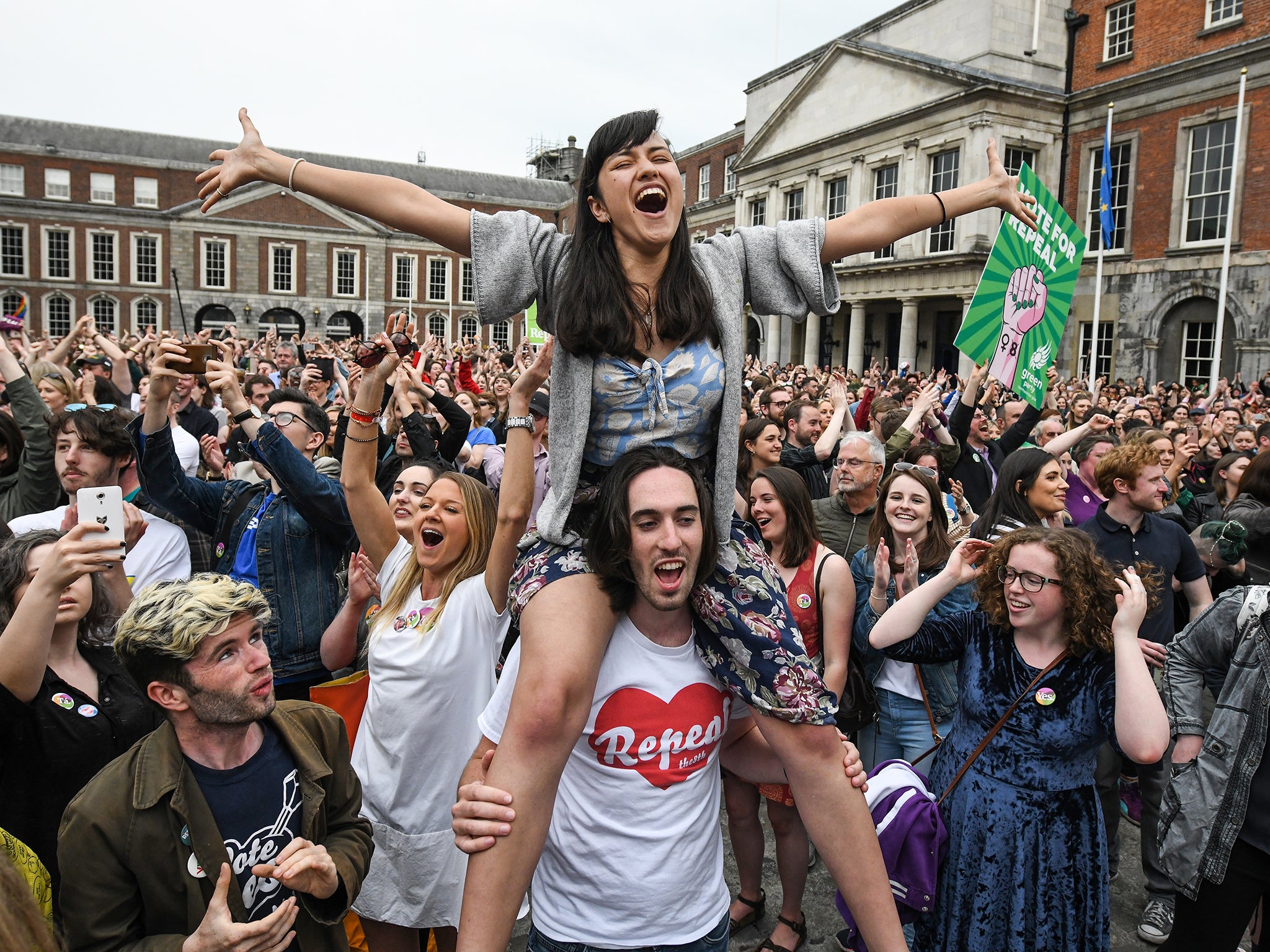 Supporters celebrate outside Dublin Castle following the result